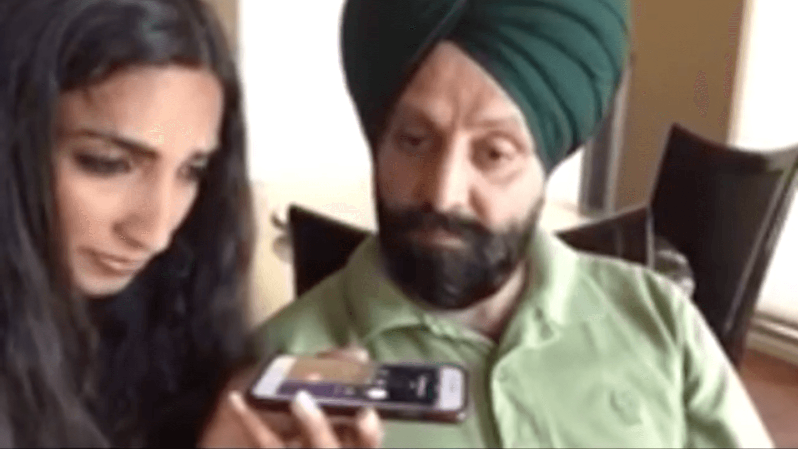 Woman and man looking at a cellphone