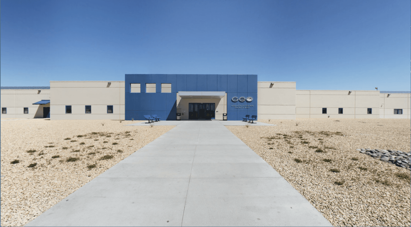 Front of Adelanto detention center with GEO Group sign