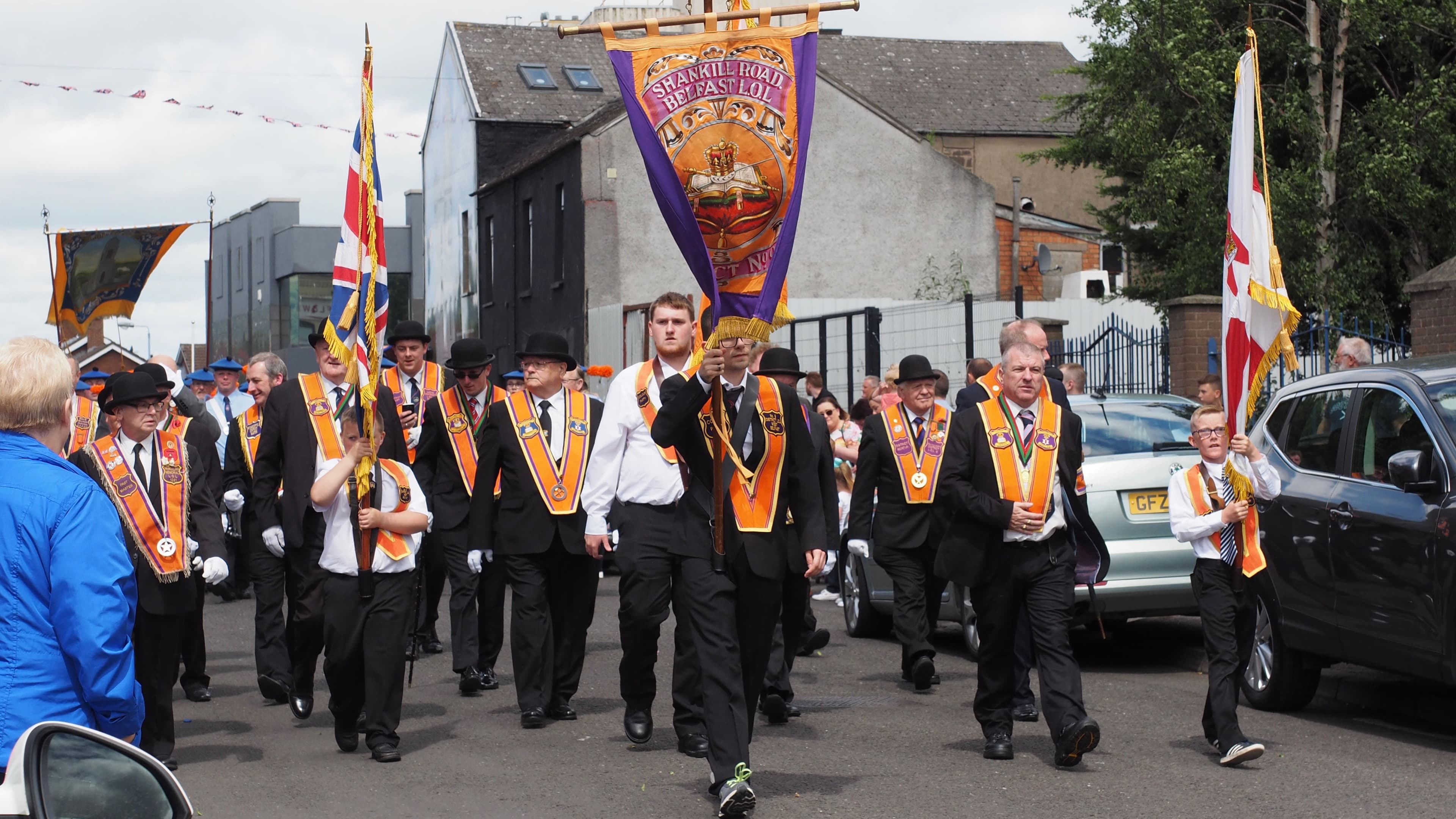 Orangemen march down Conway Street, off Shankill Road, in Belfast.