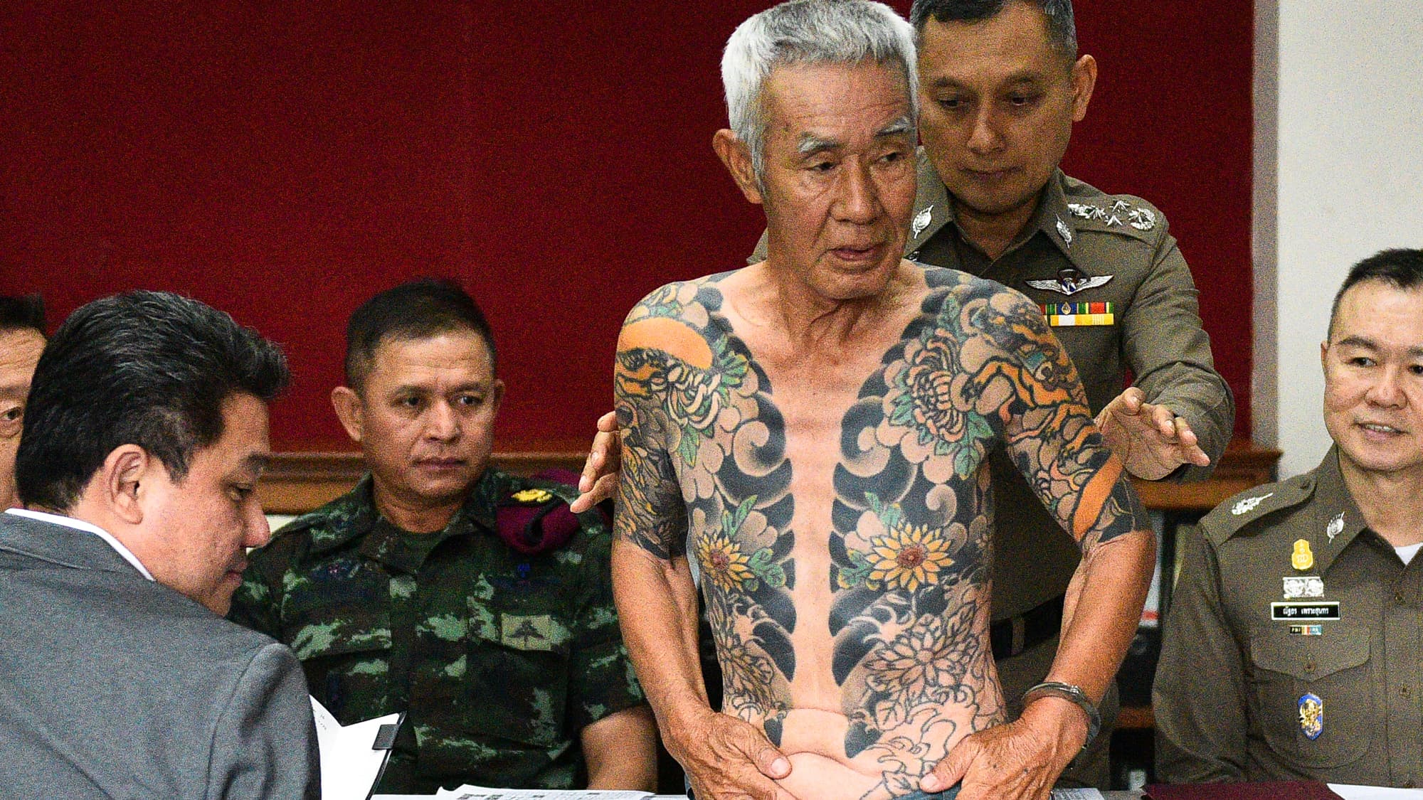 Shigeharu Shirai (C), a 74-year-old Japanese man accused of a gang murder in Japan 15 years ago attends a news conference at a police station, after being detained by police in Lopburi province, Thailand, Jan. 11, 2018.