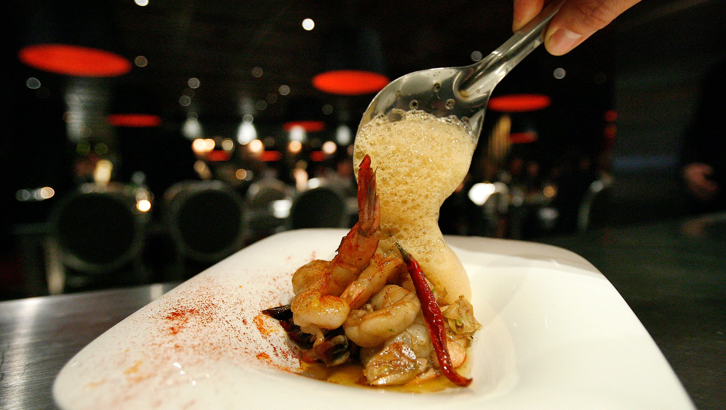 A sauteed shrimp with garlic ajillo and guindilla pepper plate is prepared at The Bazaar restaurant at the SLS Hotel in Beverly Hills, California.