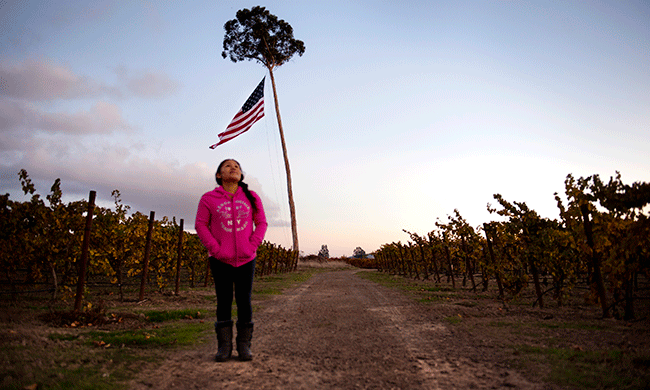 Woman in field looks up to sky