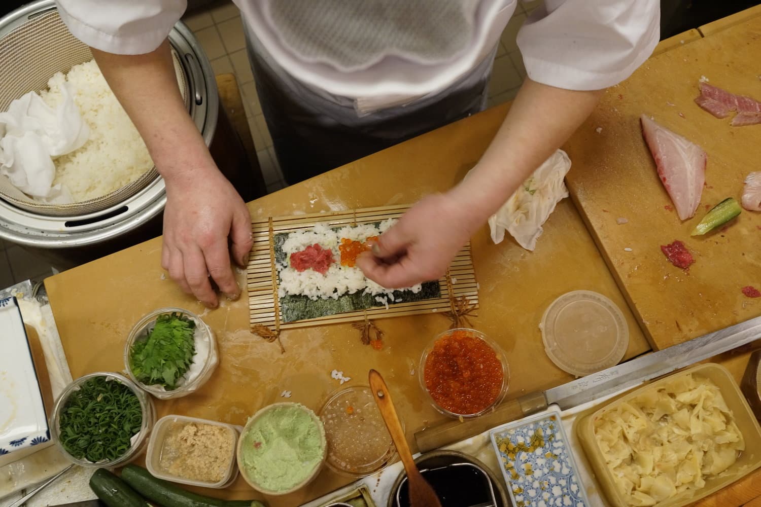 Chef Susumu Yajima carefully forms a delicious roll of sushi