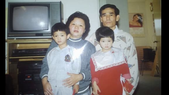 A photo of Tam Duong's family during Lunar New Year in the early 1990s. Tam, on the right in the red dress, is from Los Angeles and now lives in Boston. Her parents are from Vietnam and Duong says she was confused as to why Santa never came to their home.