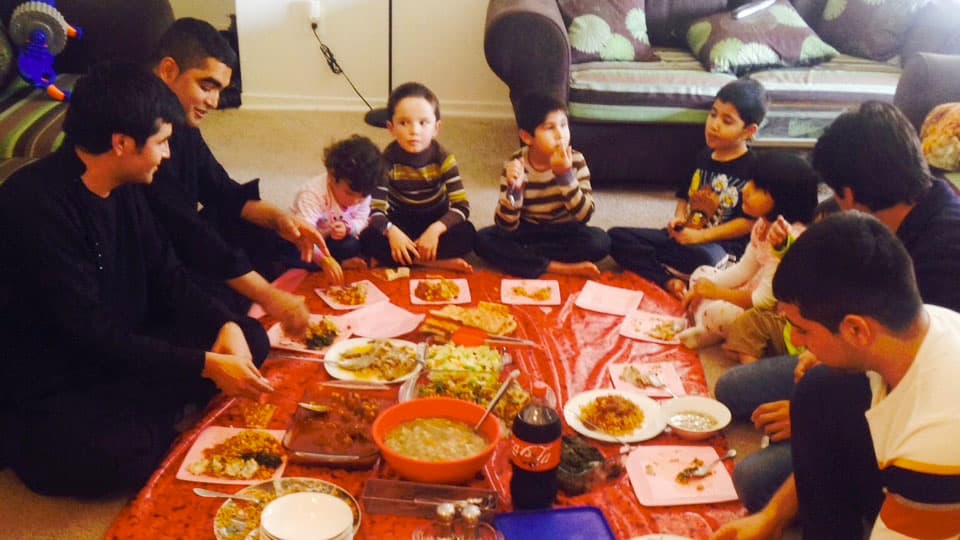 The families of former Afghan interpreters Janis Shanwari and Ajmal Faqiri gather for a holiday lunch on Thursday.