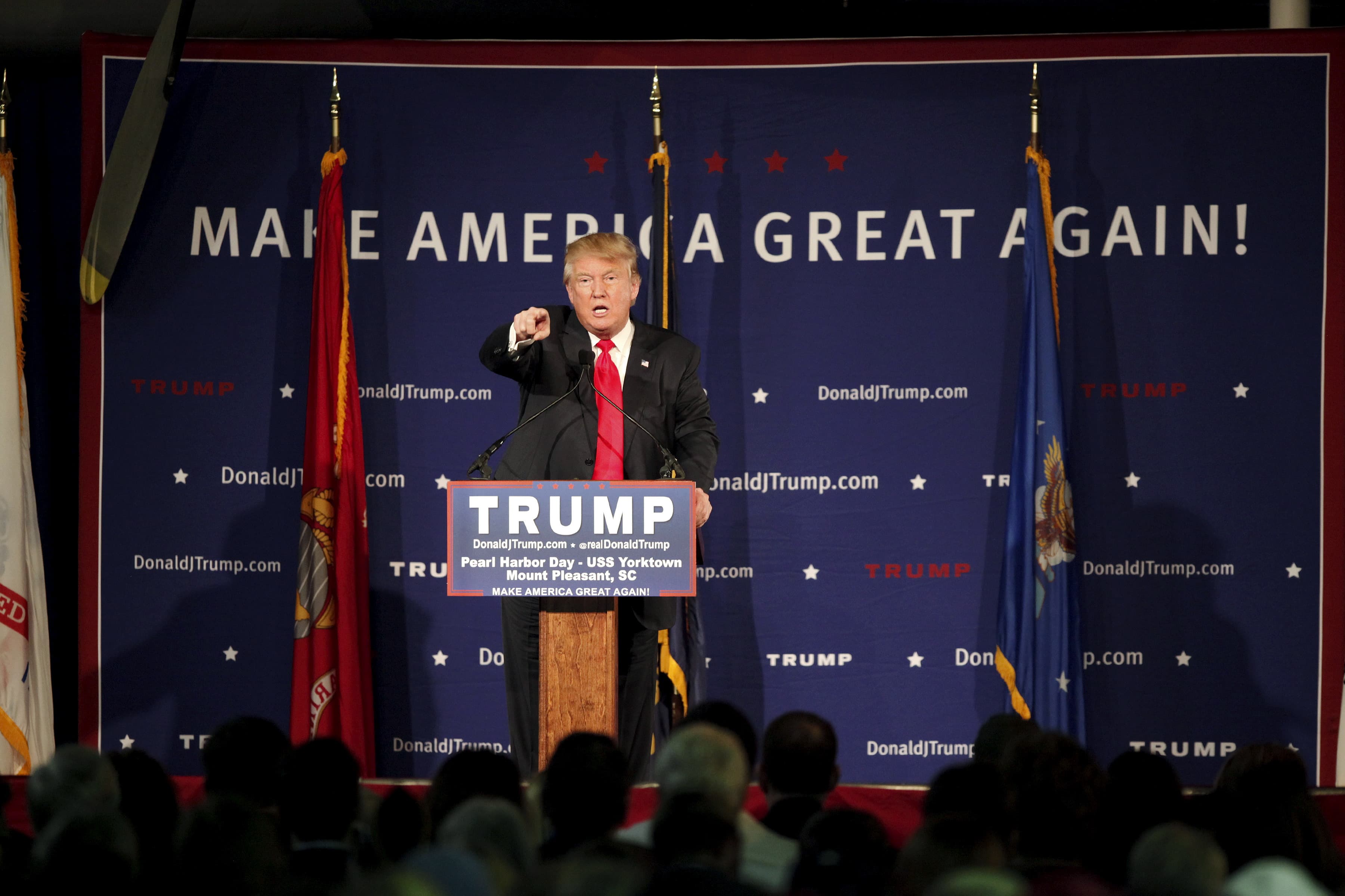 US Republican presidential candidate Donald Trump points to a supporter at a Pearl Harbor Day rally aboard the USS Yorktown Memorial in Mount Pleasant, South Carolina, December 7, 2015. Trump on Monday called for a ban on Muslims entering the United State