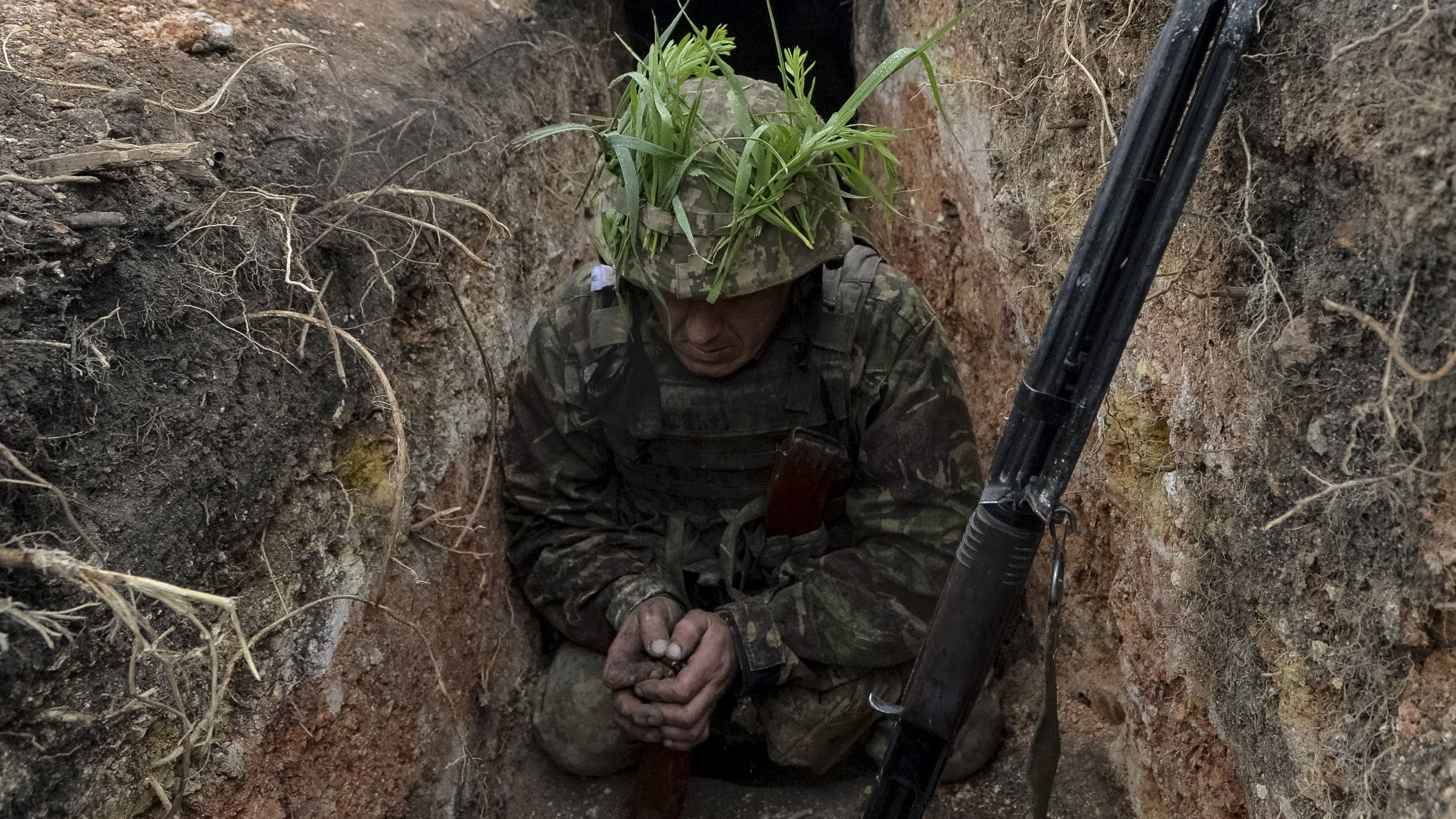A Ukrainian service member loads magazines at his position on the front line in the government-held town of Avdiyivka