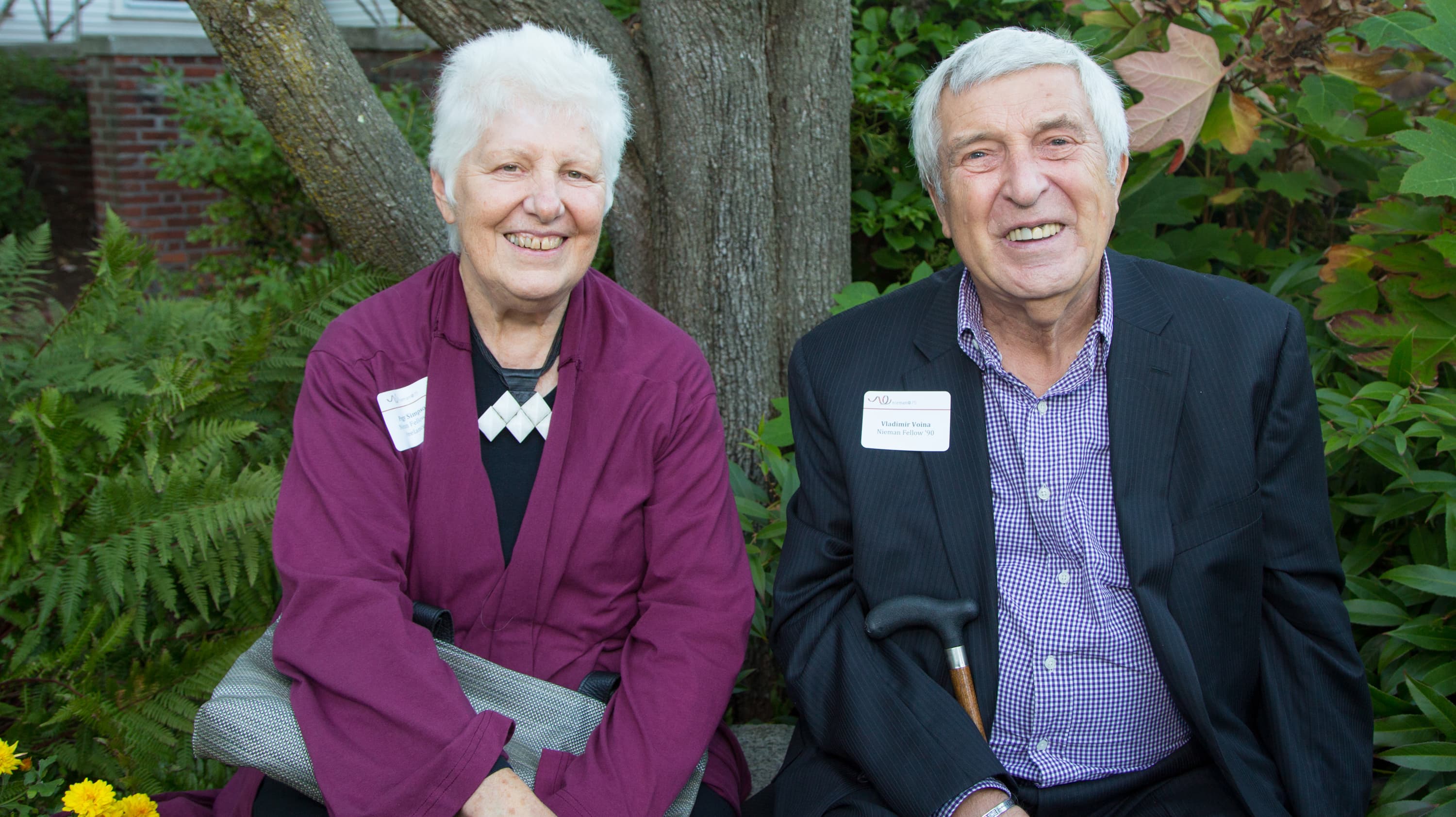 Vladimir Voina, a journalist from Russia who moved to the US in 1989, sits at a journalism reunion in Boston with reporter Peg Simpson.