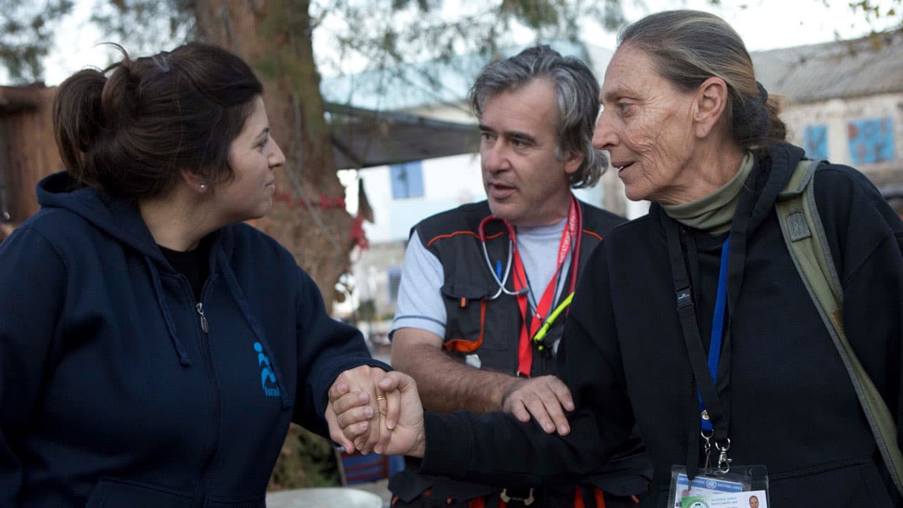 Dr. Zoi Livaditou (R) greets Dr. Shimrit Eliyah of Israid in Skala Sykaminia, Lesbos, Greece. Dr. Andreas Iliadis looks on.