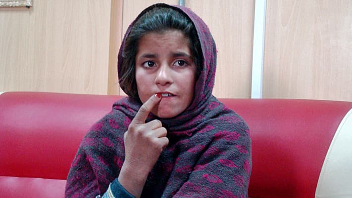 An Afghan girl named Spozhmai is held in a border police station in the southeastern part of Helmand province, Afghanistan.