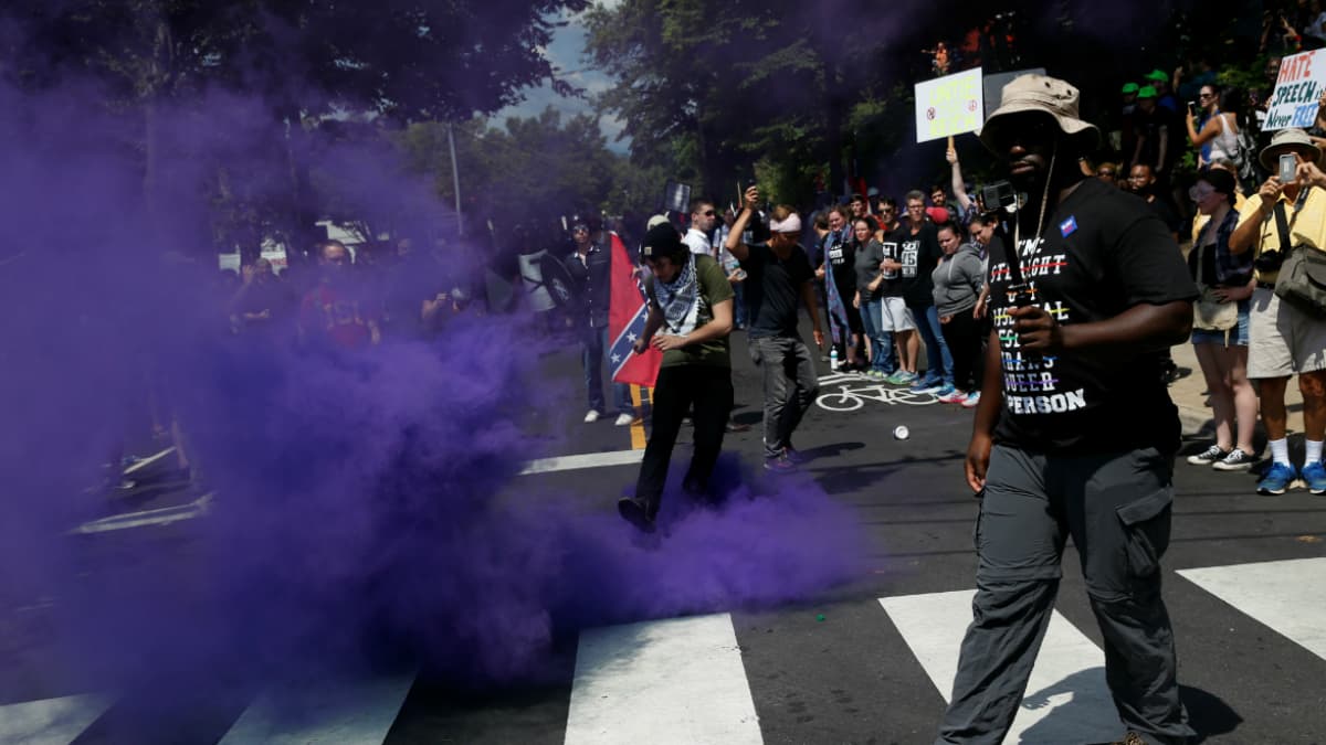 A smoke bomb is thrown at a group of counter-protesters during a clash against members of white nationalist protesters in Charlottesville, Virginia, U.S., August 12, 2017.