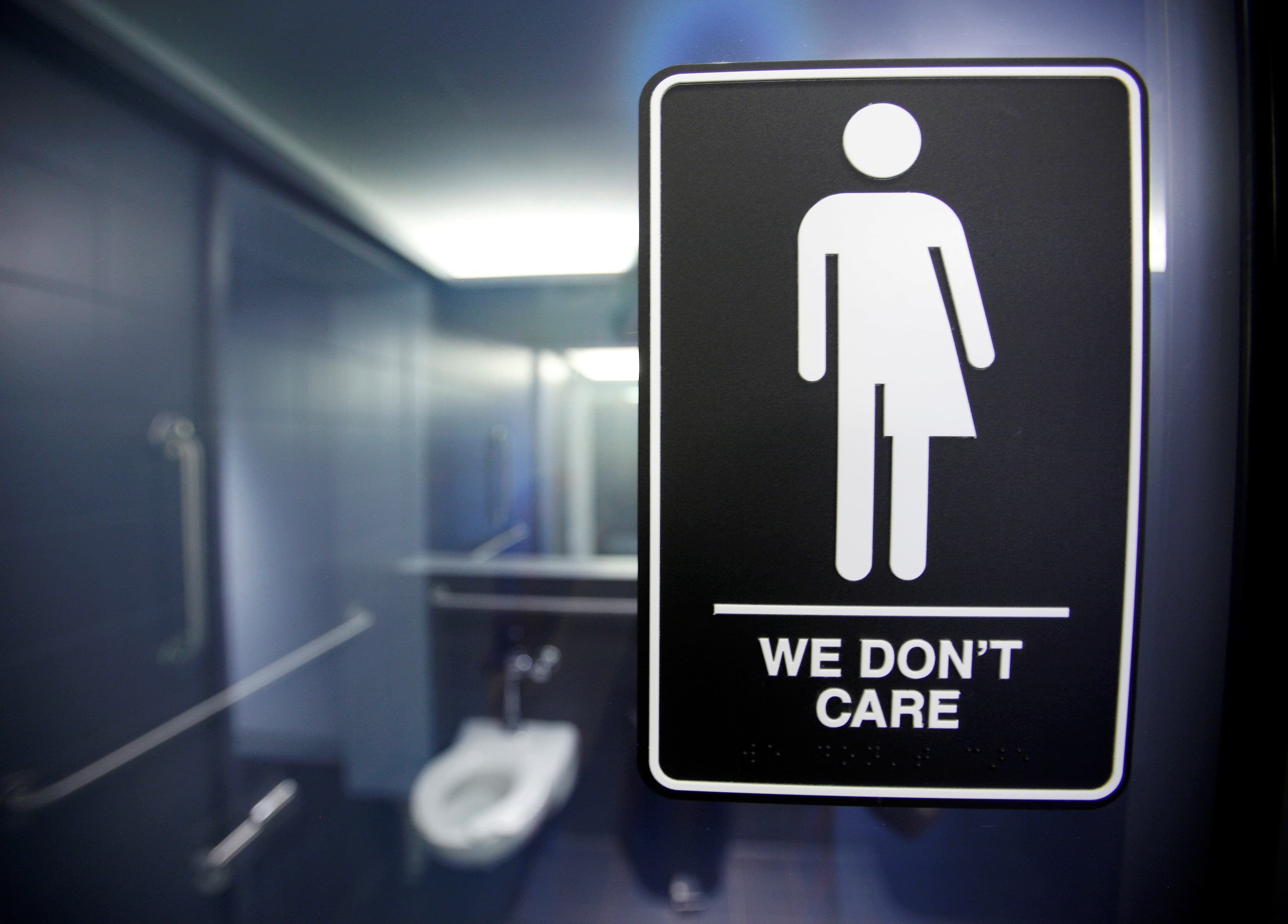 A sign protesting a recent North Carolina law restricting transgender bathroom access adorns the bathroom stalls at the 21C Museum Hotel in Durham, North Carolina