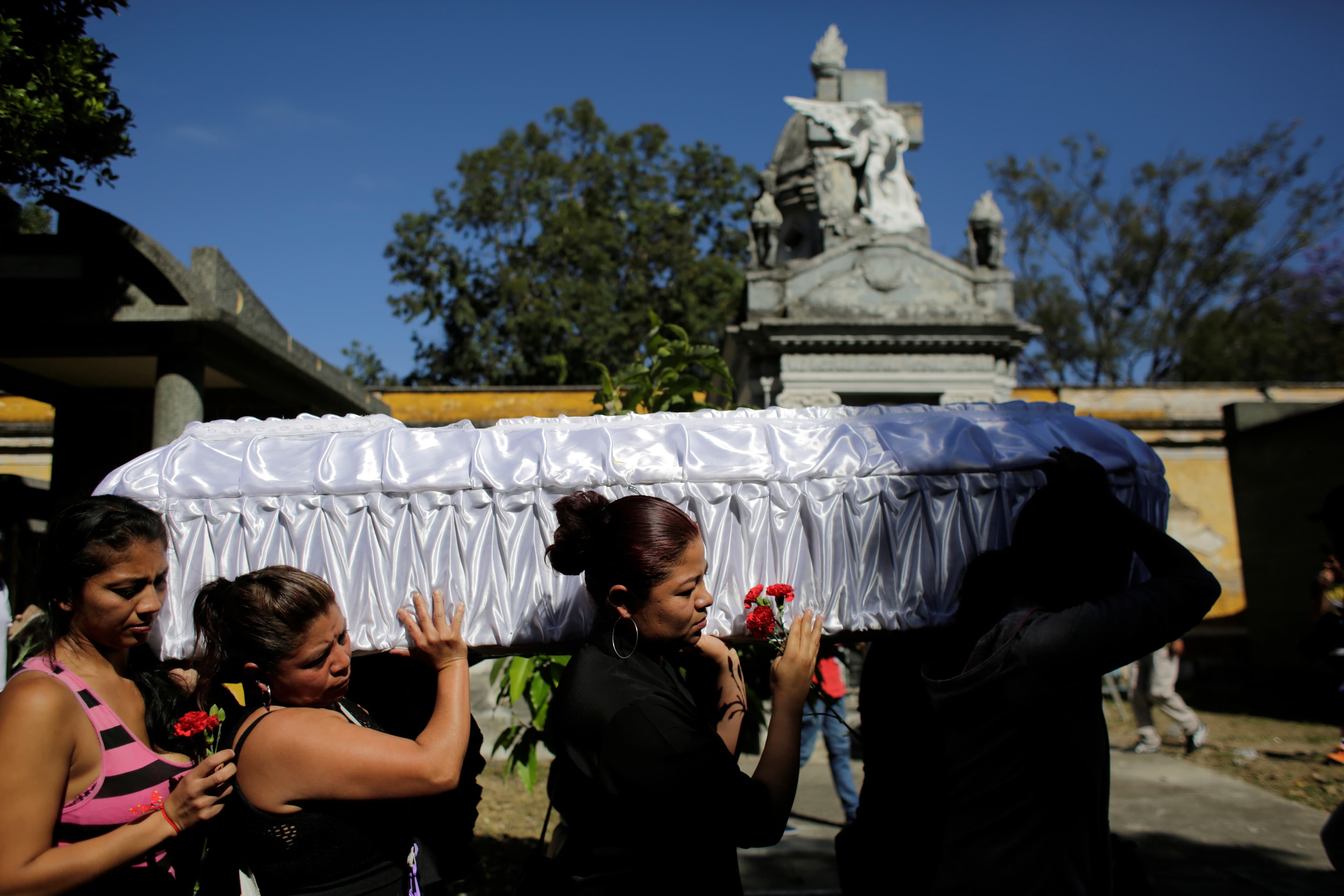 Relatives and friends carry the coffin of Kimberly Palencia