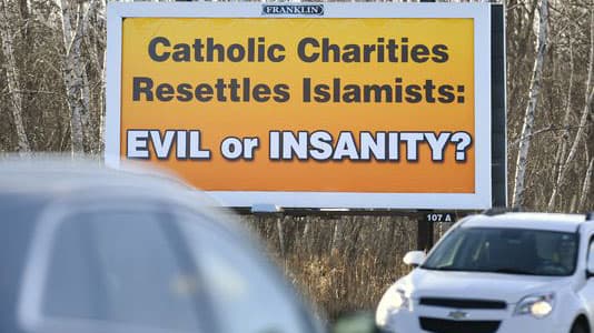 A billboard in Waite Park, Minnesota, near St. Cloud. The owner agreed to take it down because Catholic Charities does not resettle refuguees in the area.