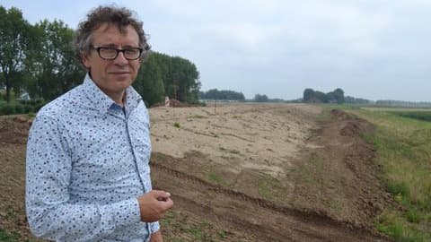 Dutch ecologist and dike designer Mindert de Vries stands on top of one of the new "soft" dikes being built near the Rhine River delta city of Dordrecht. Dutch innovations in flood control are helping reduce the adverse effects of older dike technologies.