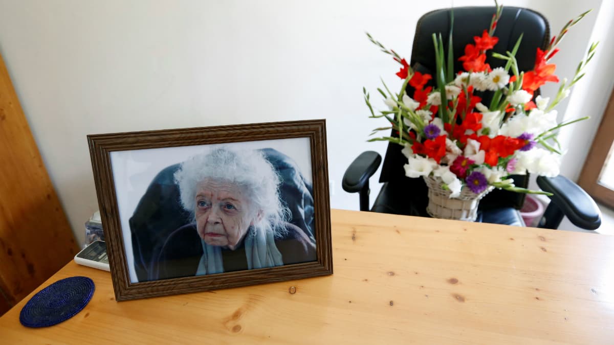 A photograph of Nancy Hatch Dupree, and a bouquet of flowers are seen in her office after she passed away, in Afghanistan Centre at Kabul University (ACKU), in Kabul, Afghanistan September 10, 2017.