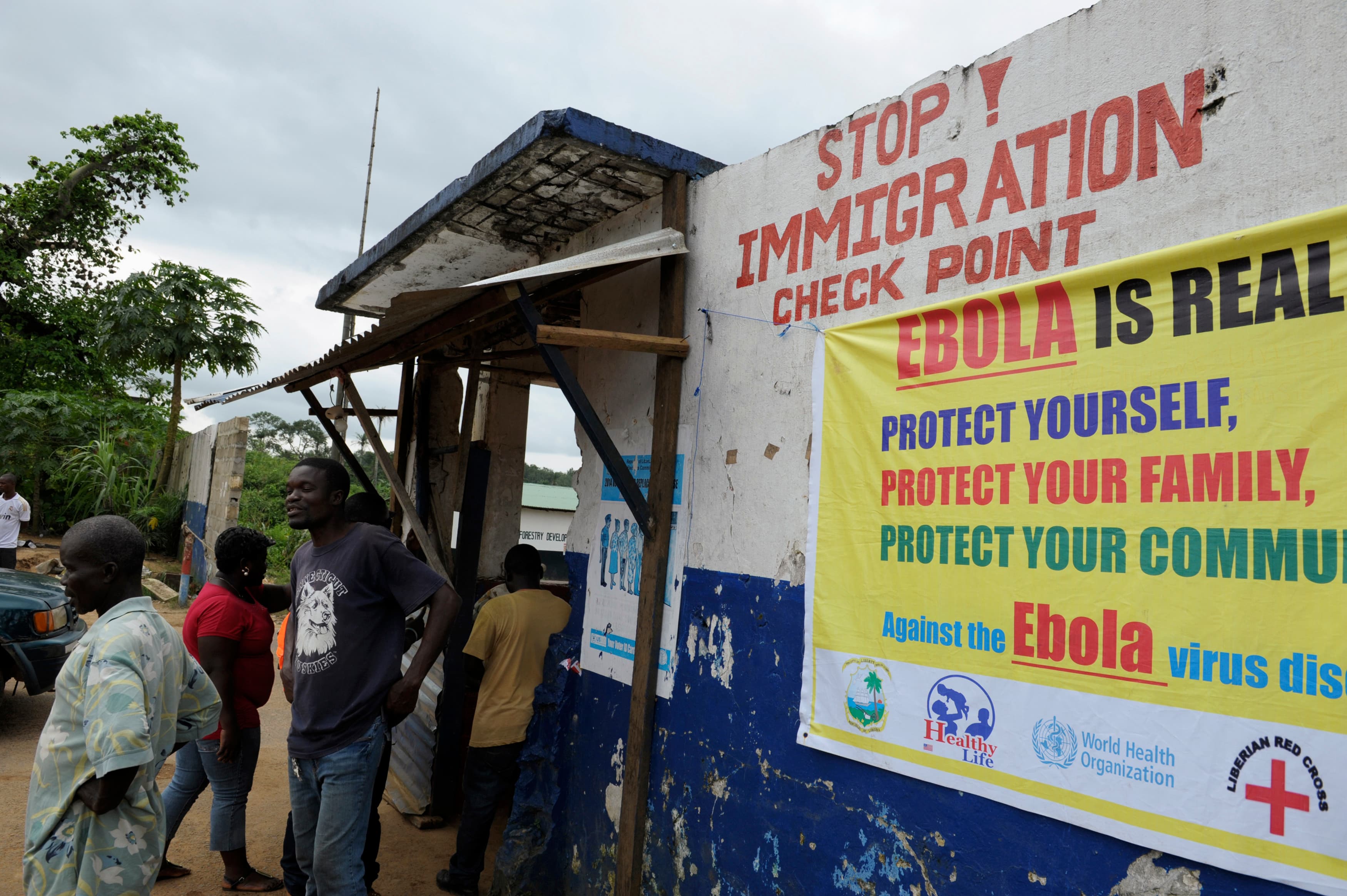Liberian soldiers check people for Ebola