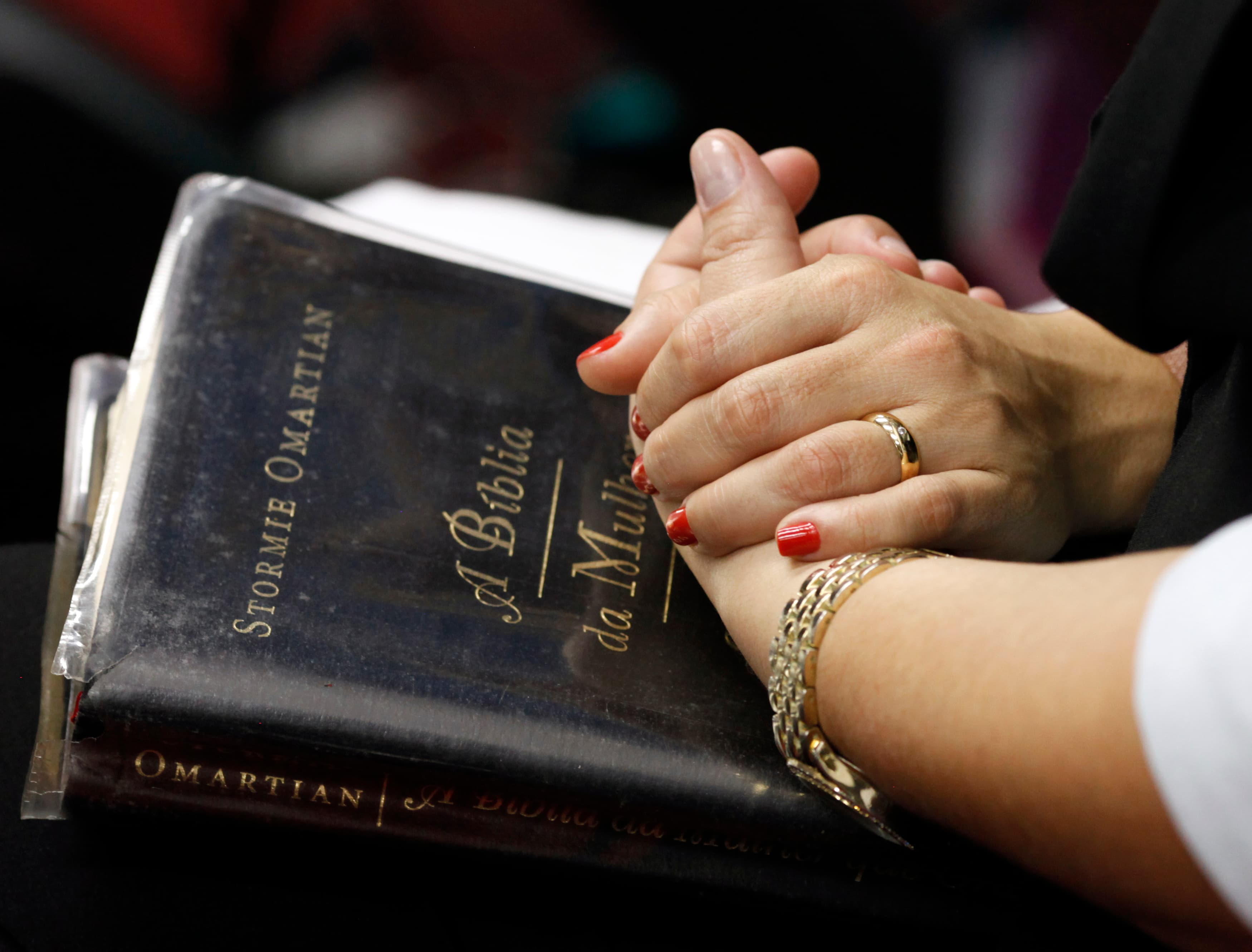 Evangelical worshipers pray during a mass held by missionary Lanna Holder and her partner Pastor Rosania Rocha, in the Cidade de Refugio church they founded, in Sao Paulo June 16, 2012.