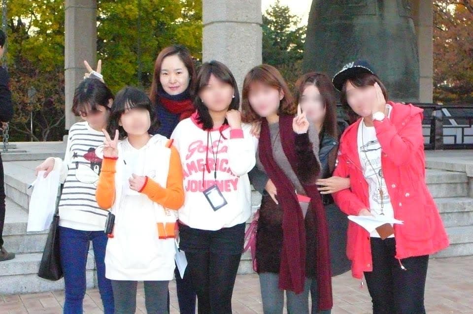 Students from the Daum School on a field trip with their teacher. Their faces are blurred to protect their privacy. Many North Korean refugees have trouble adjusting to life in fast-paced South Korea, especially at school.