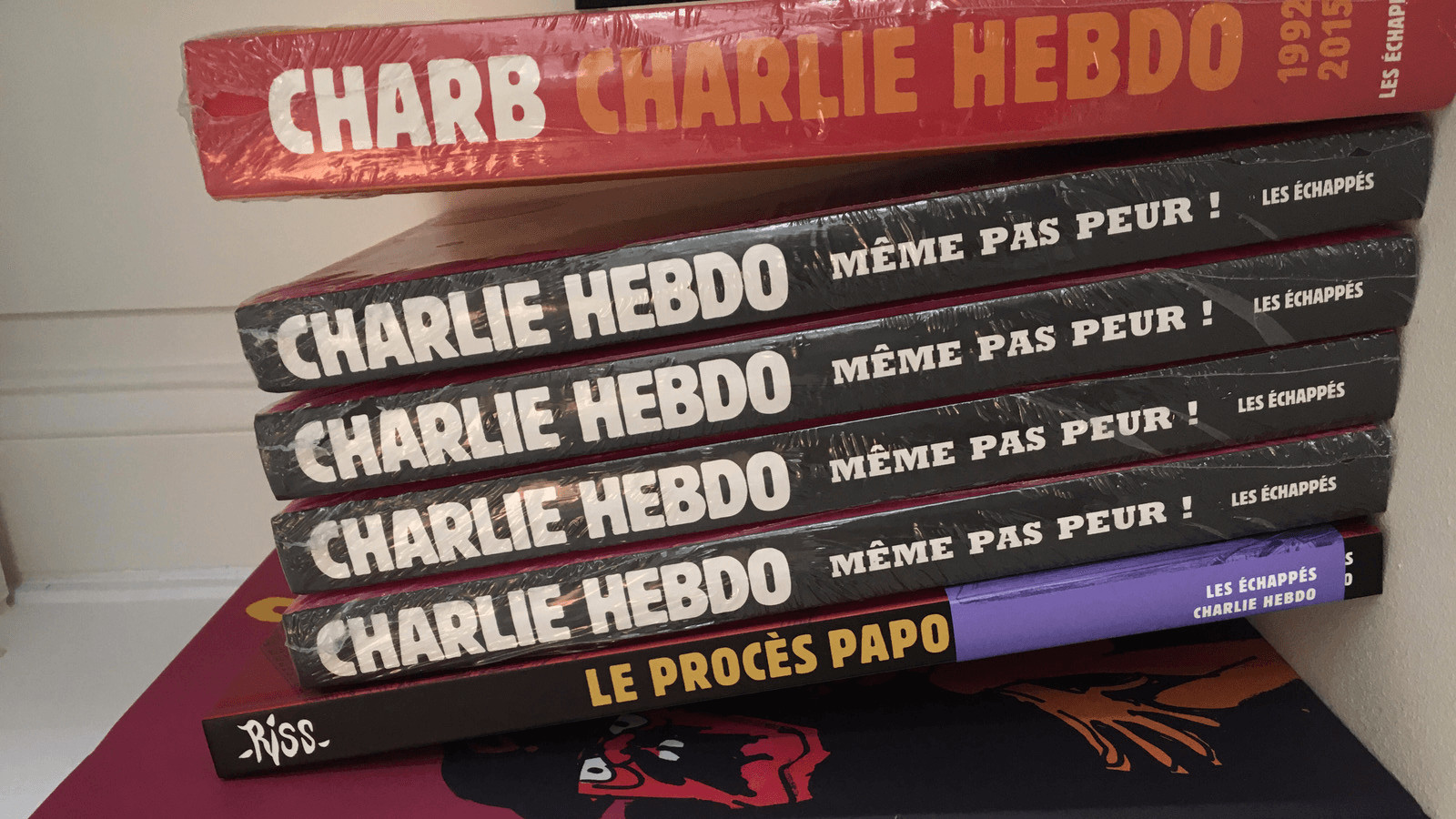 A stack of Charlie Hebdo cartoon collections in the publicity office of the satirical newspaper in in Paris.