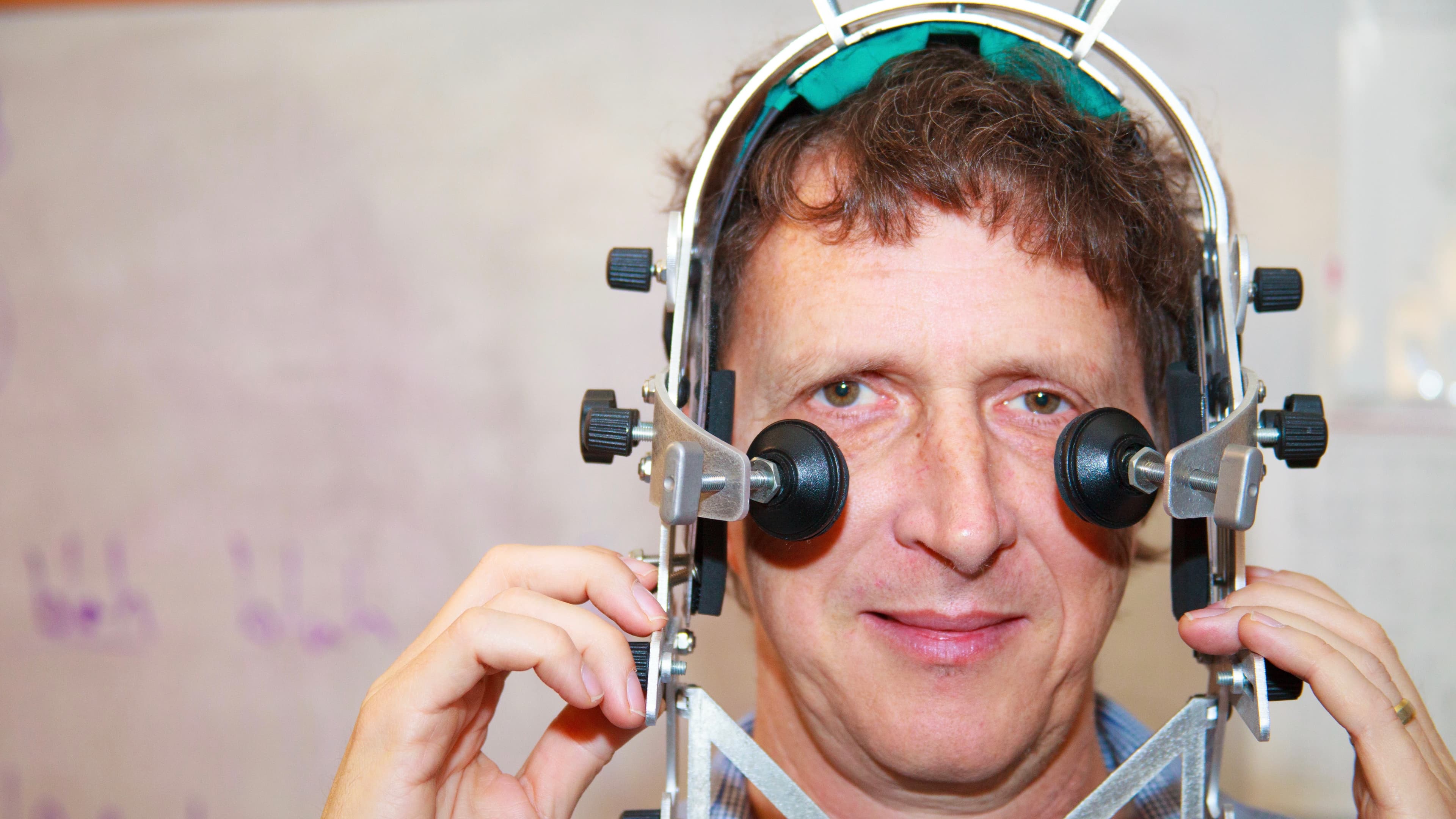 Linguist Jaye Padgett wearing the head frame used to stabilize an ultrasound camera. Padgett and colleagues at UC-Santa Cruz and University College Dublin are documenting Irish consonant formation.