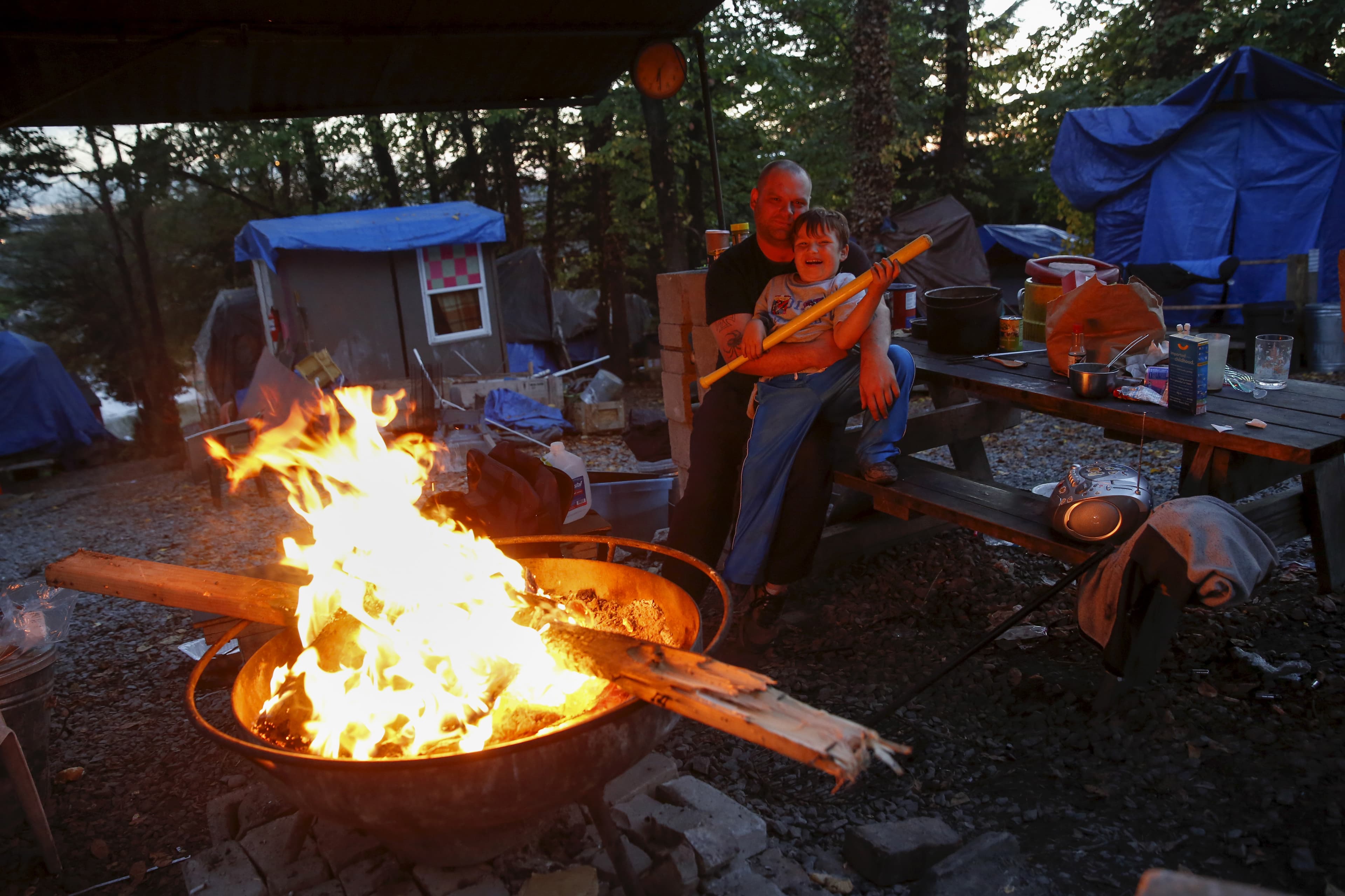 Matt Hannahs, 32, poses with his son Devin outside their tent
