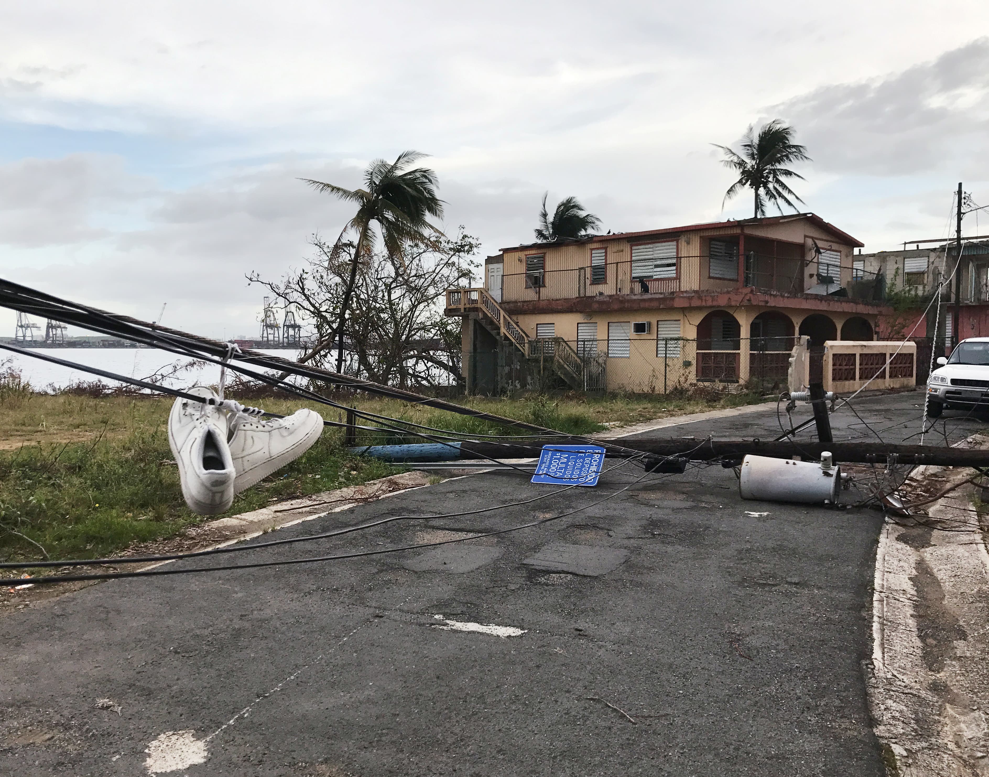 Sneakers hang from downed wires in the wake of Hurricane Maria