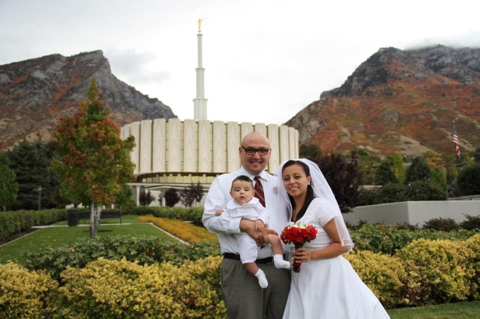 Laura López with her husband and first child on her wedding day.