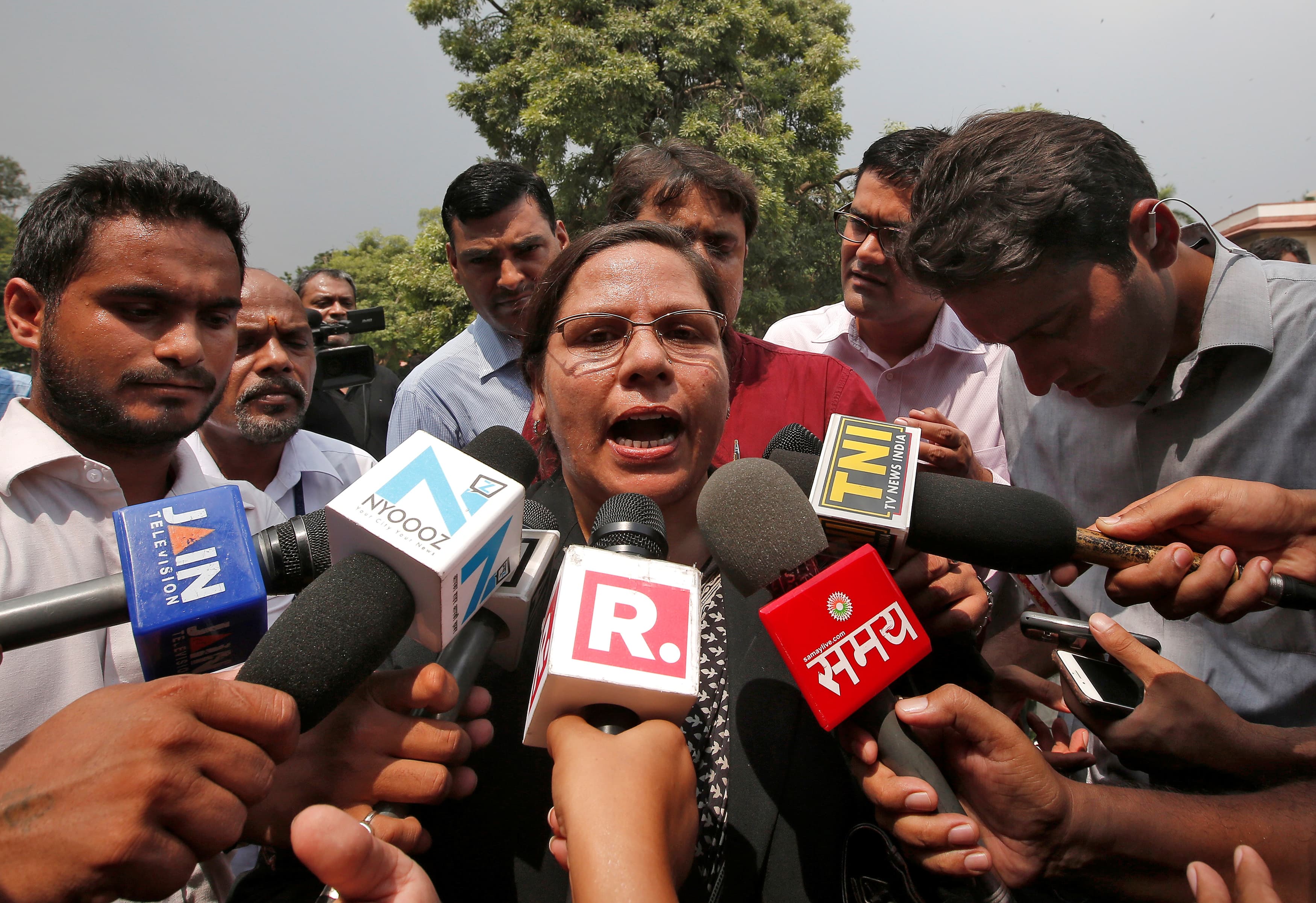 Farha Faiz, a lawyer, speaks with the media