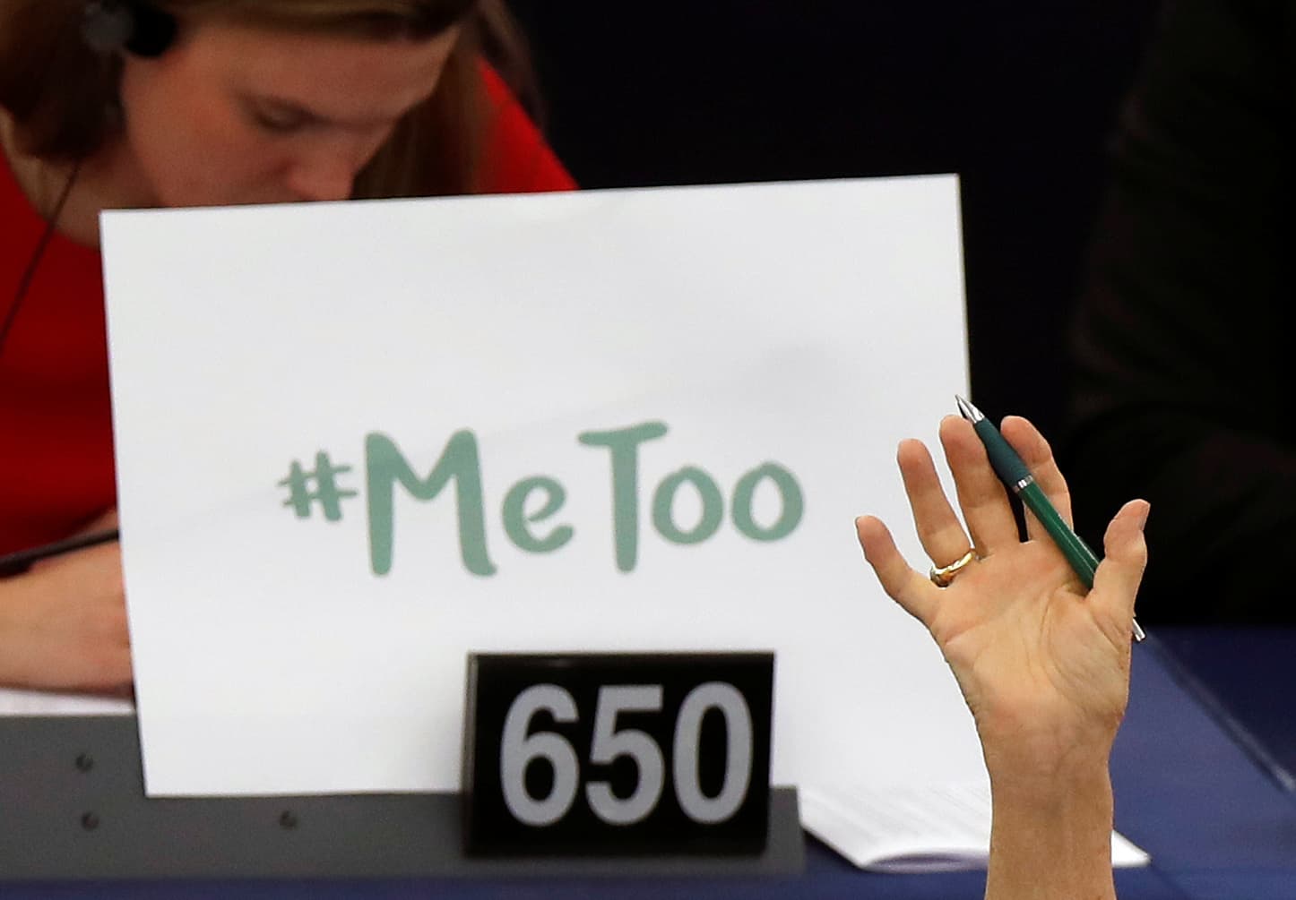 The sign #MeToo is propped up on a European Parliament member's desk during a session to discuss preventive measures against sexual harassment and abuse.