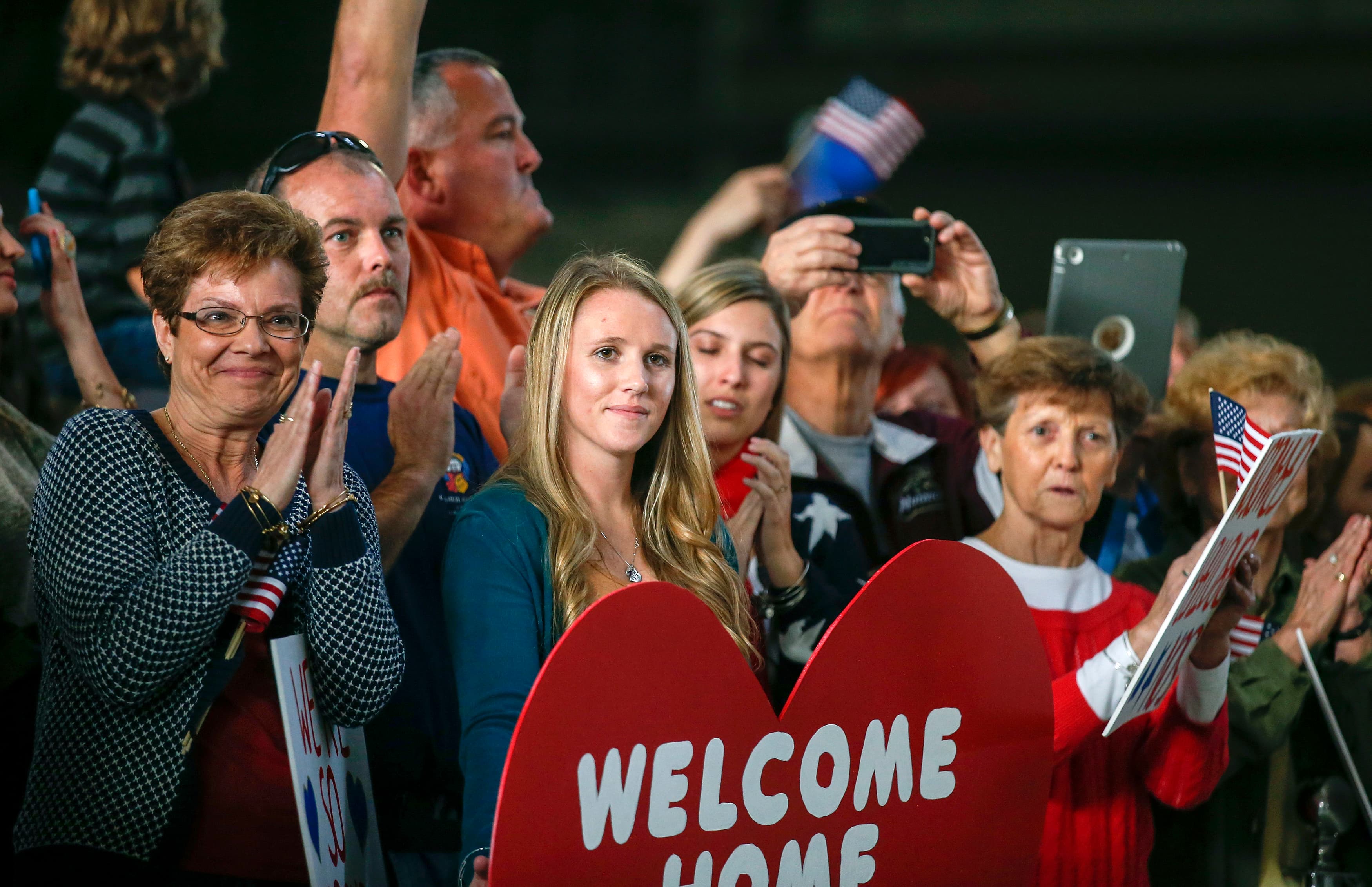Friends and family await loved ones' return.