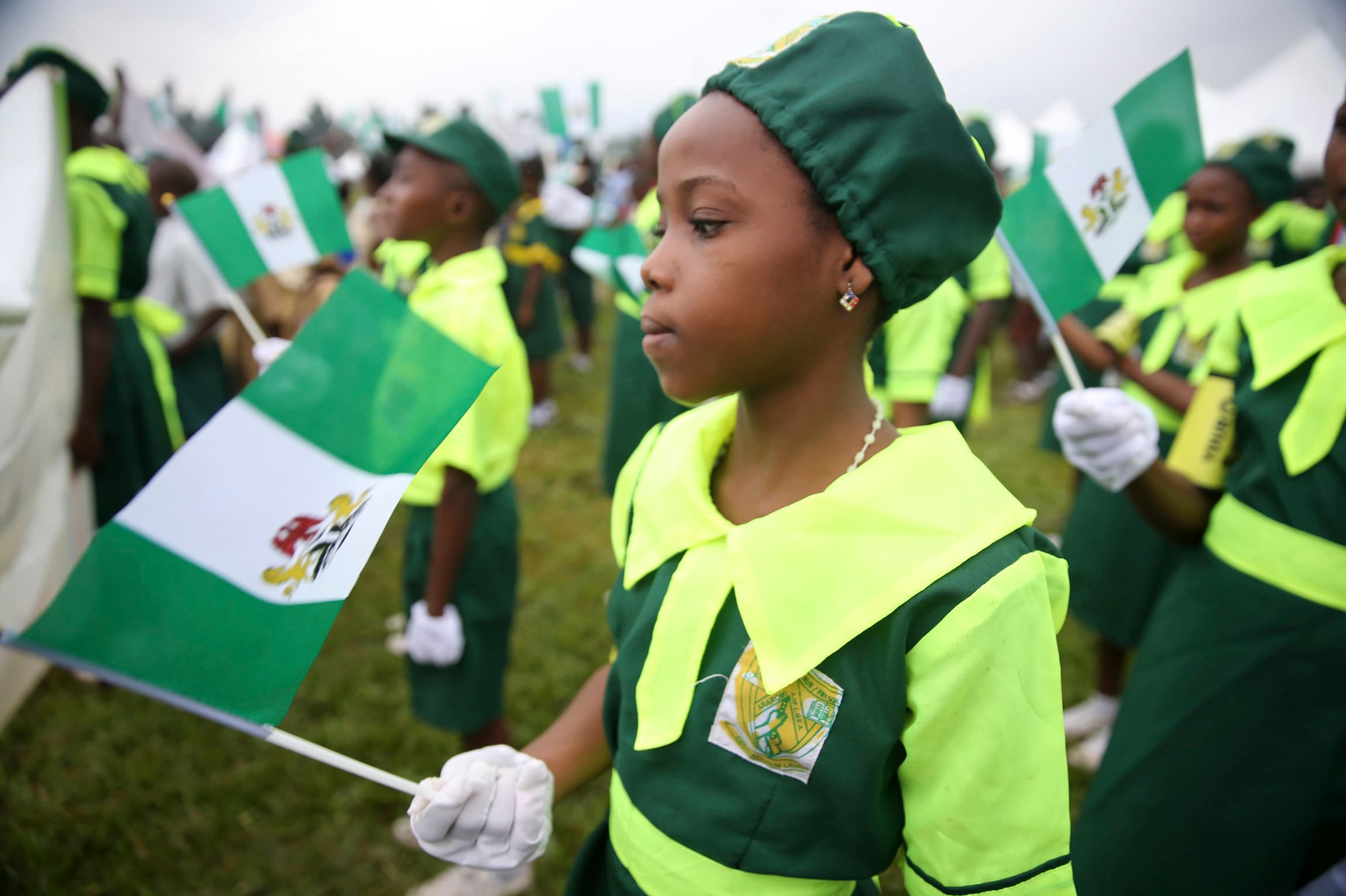 A school girl holds a Nigerian flag as she joins a parade marking Nigeria's 54th Independence Day in Lagos October 1, 2014.