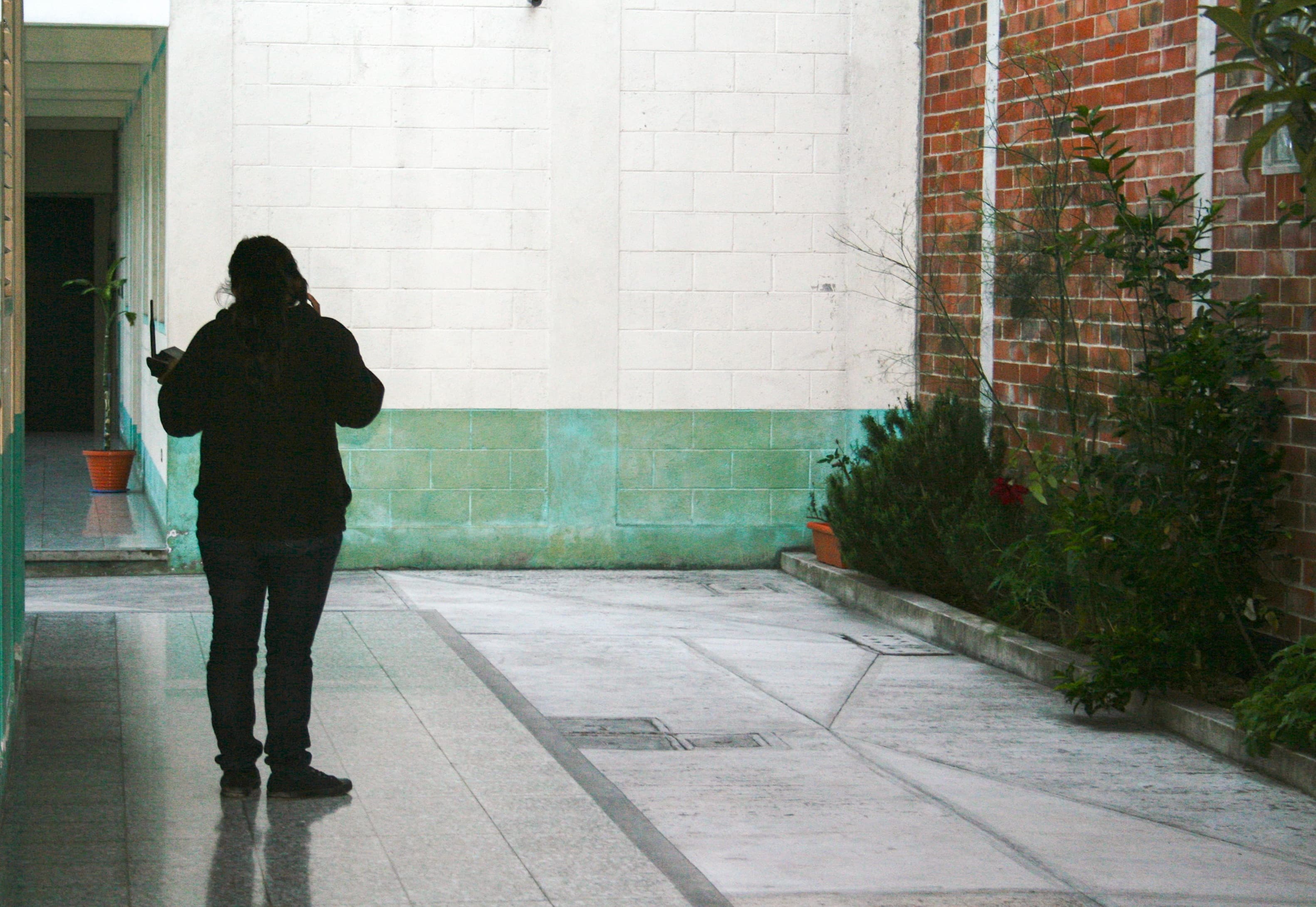 A Guatemalan woman recently deported from the U.S. makes a phone call at a migrant shelter in Guatemala City, In addition to avoiding gang and drug-related violence, Central Americans are also fleeing to the US for economic reasons.