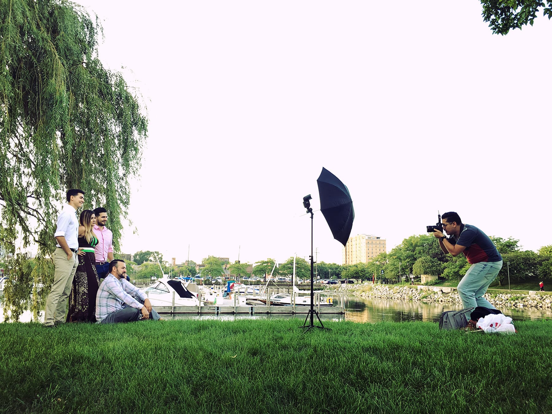Photographer shoots family across green field