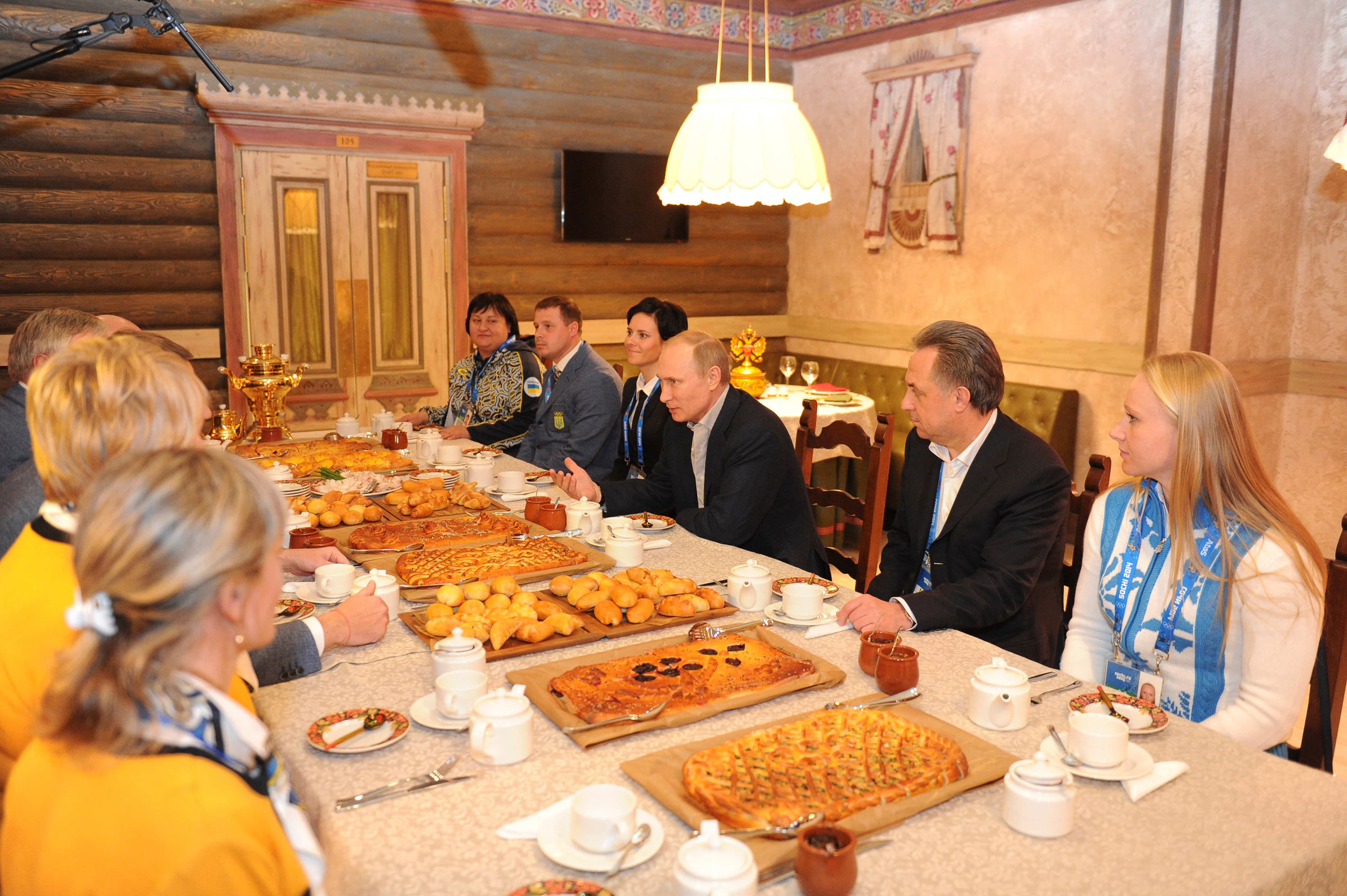 Russia's President Vladimir Putin (C) visits Team Ukraine House at the Olympic Park during the Sochi 2014 Winter Olympics Games February 15, 2014.
