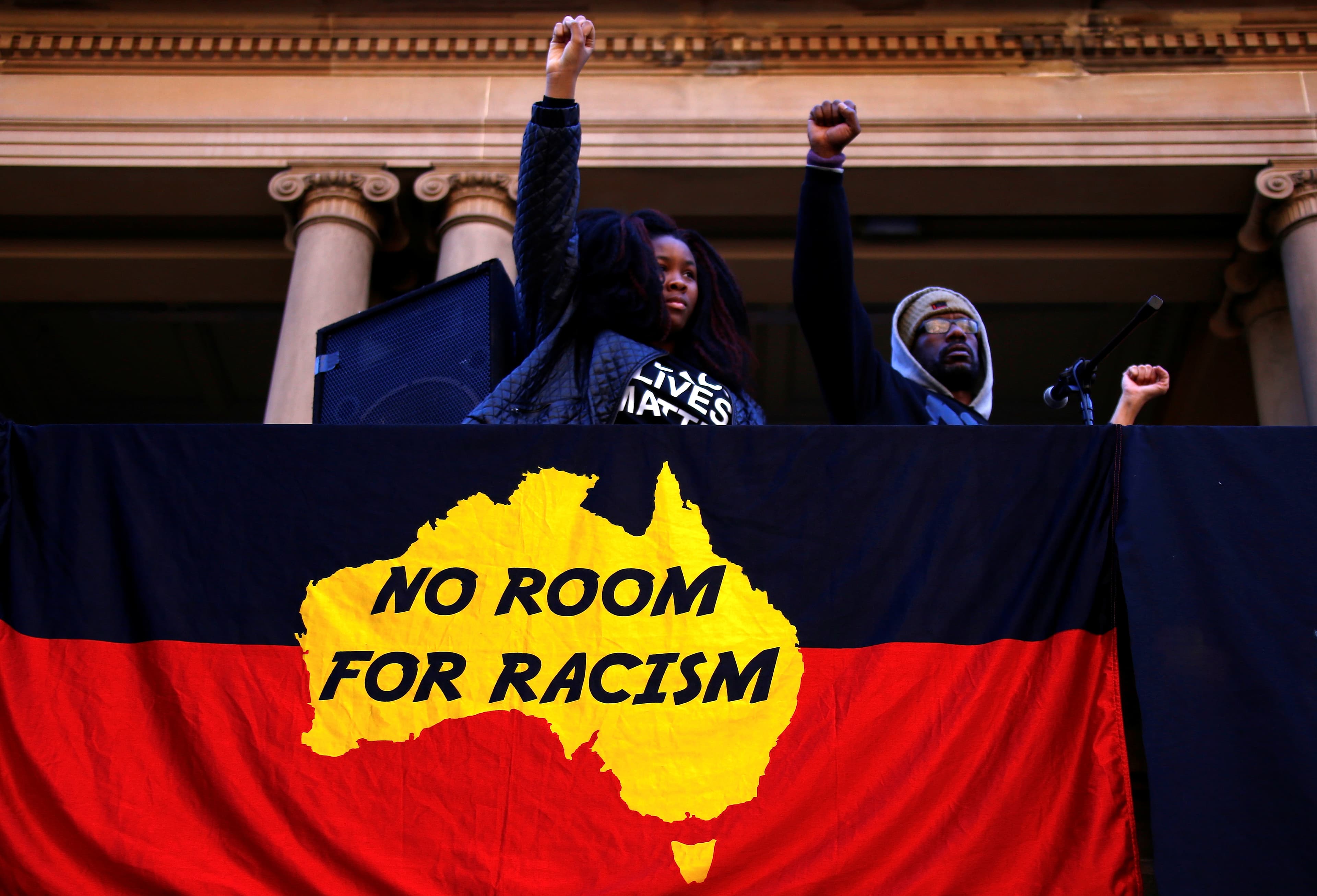 Protesters raise their fists during a rally
