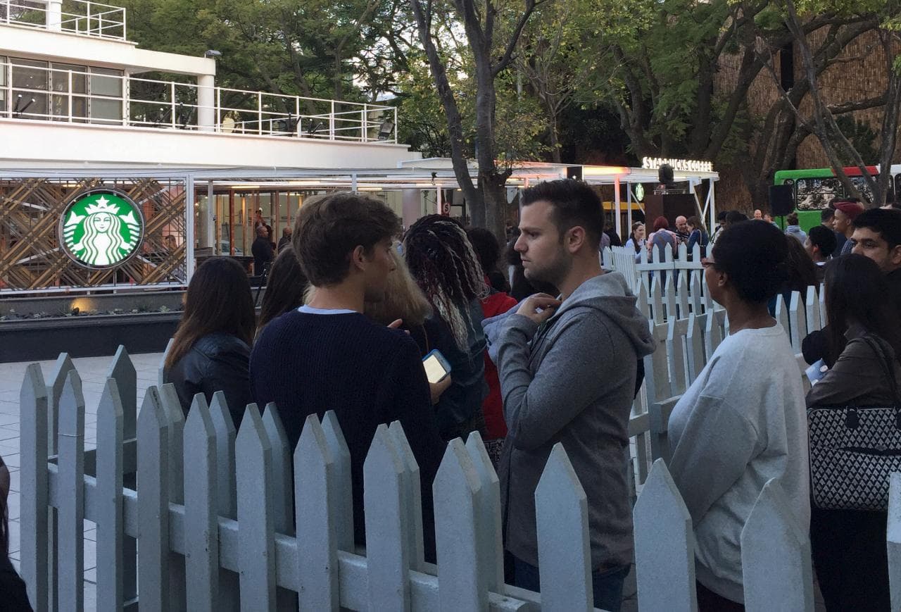 Customers queue for coffee outside South Africa's first Starbucks outlet in Johannesburg, South Africa.