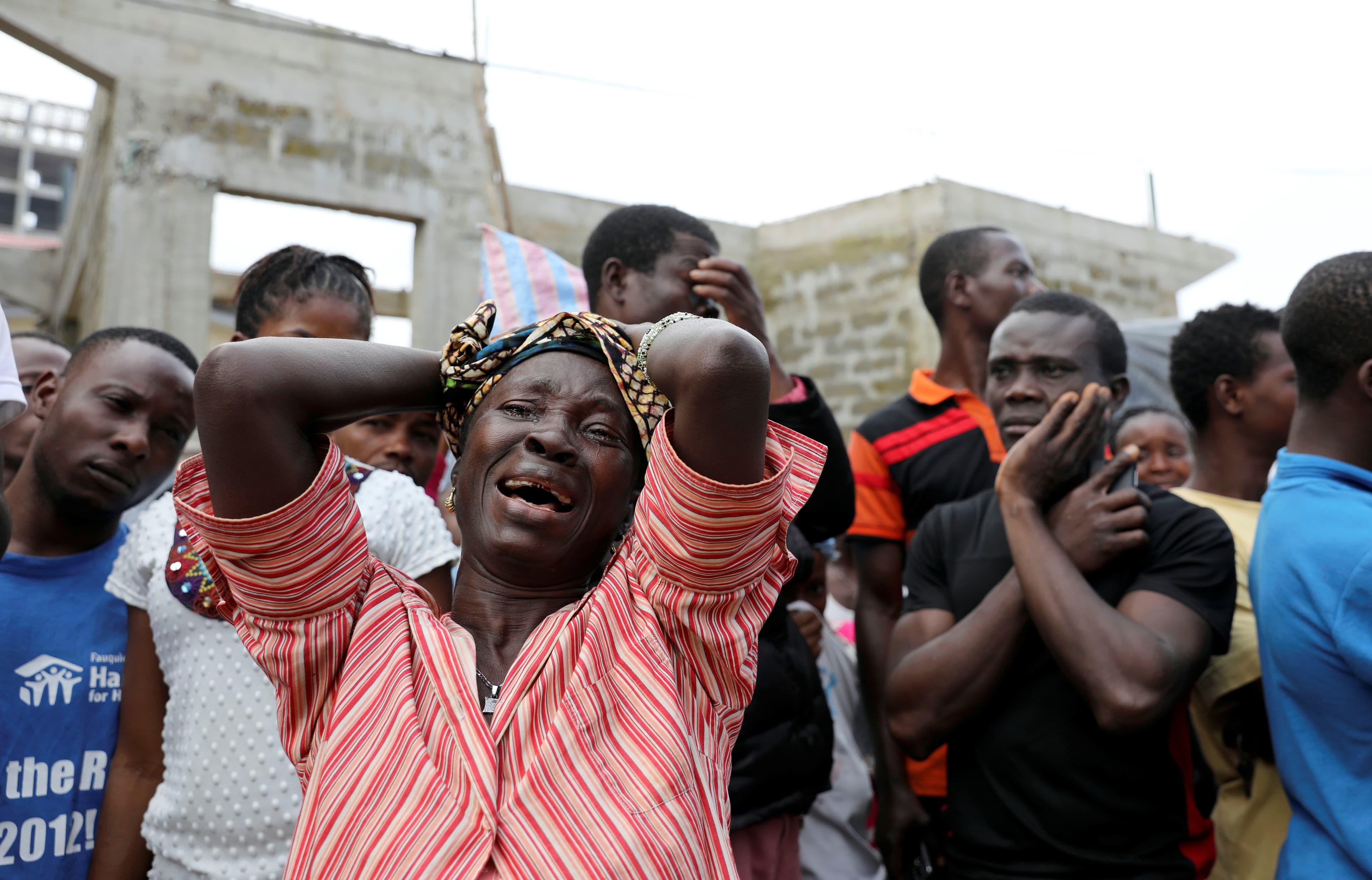 A woman mourns for her son at the entrance of Connaught Hospital