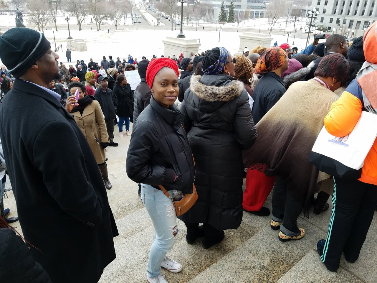 Woman in crowd looking at camera