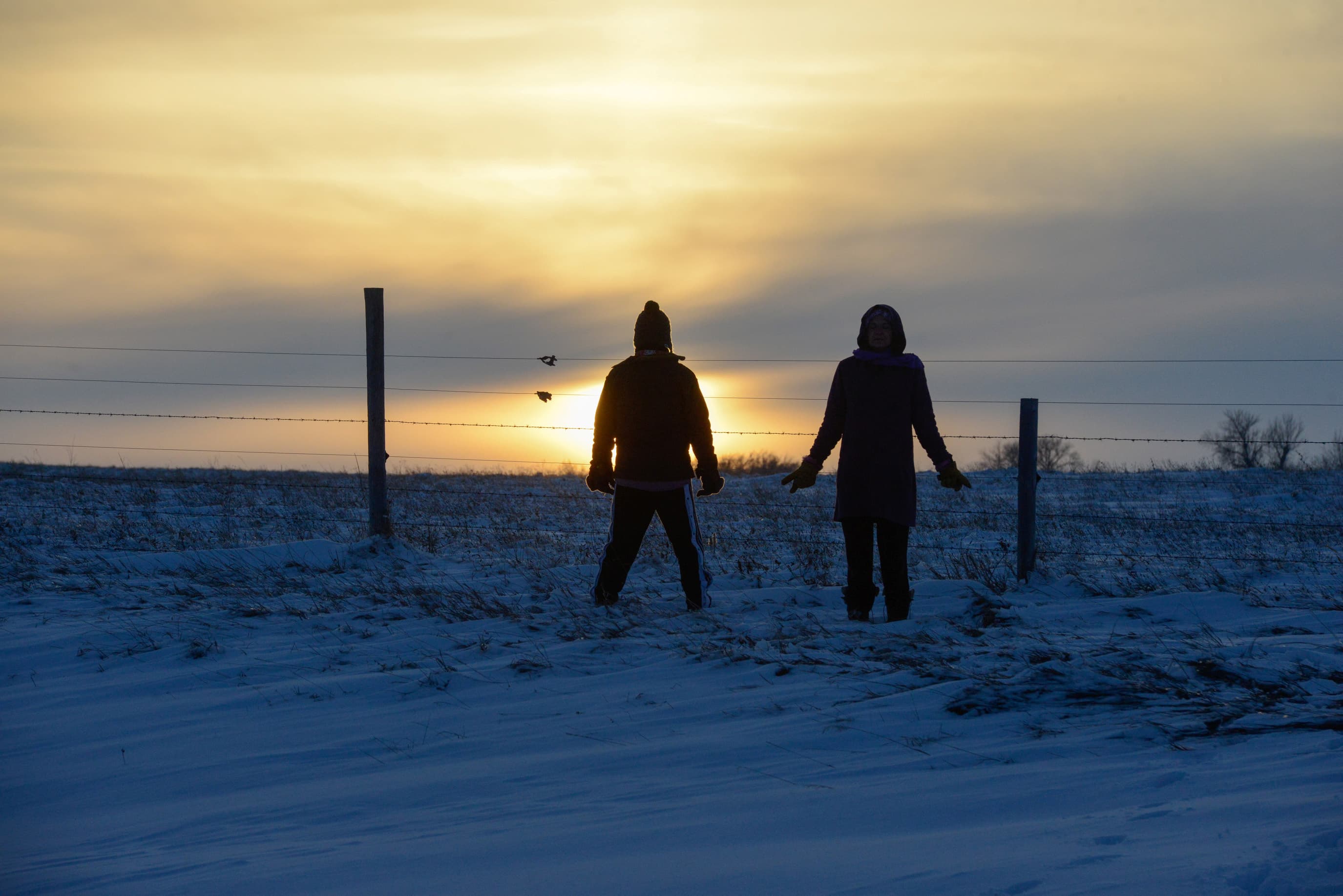 Two people watch the sunset