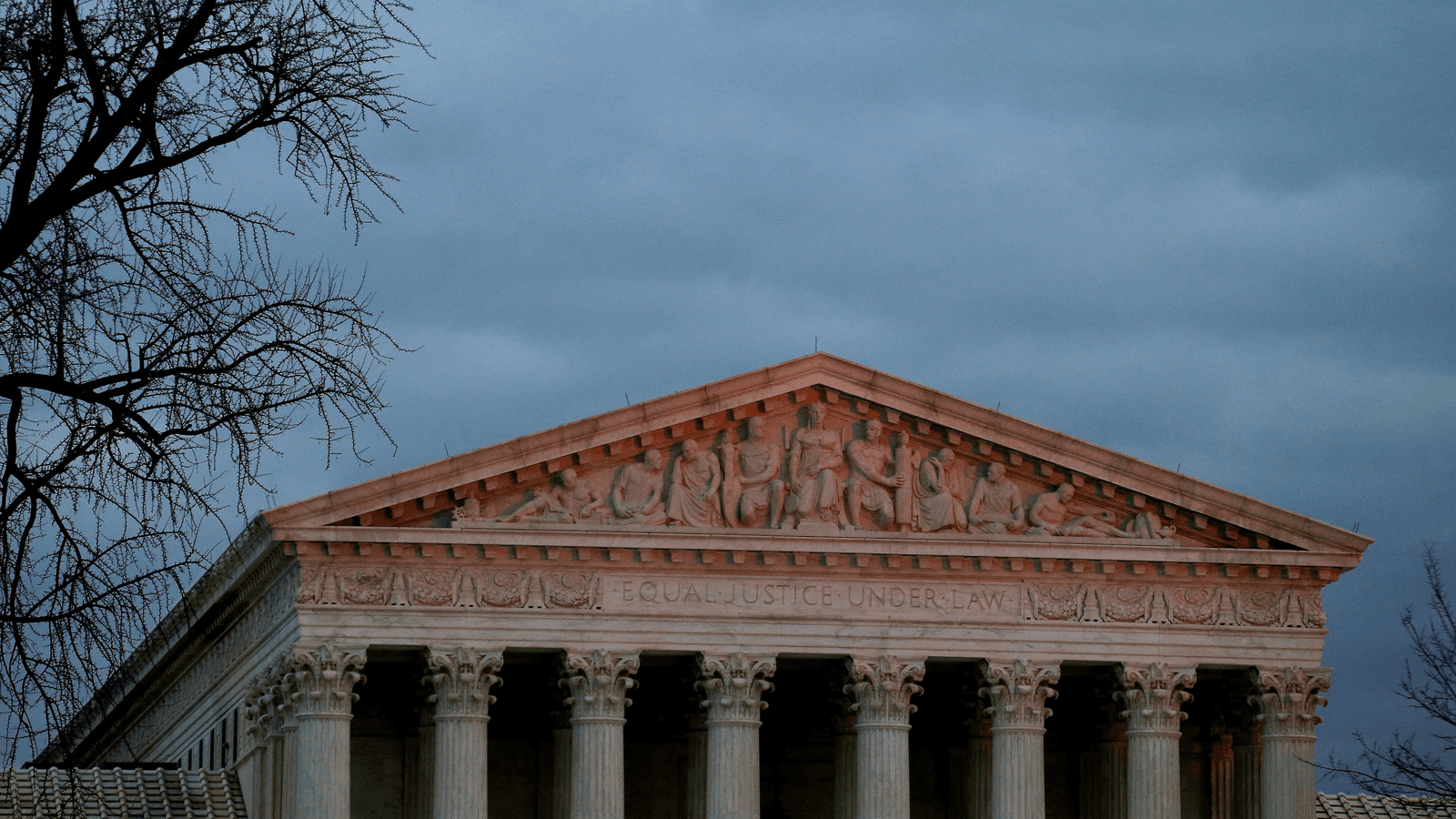 The top of US Supreme Court building is lit at dusk in Washington, Dec. 18, 2017.