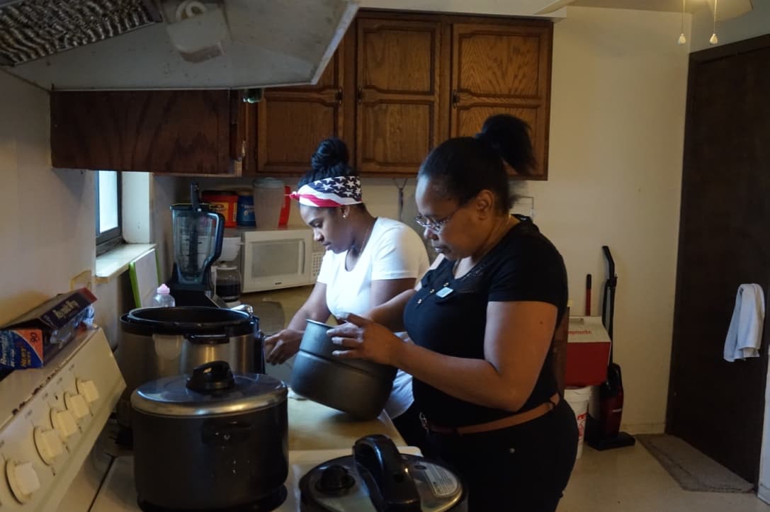 Heidy and Gregoria prepare dinner, rice and eggs