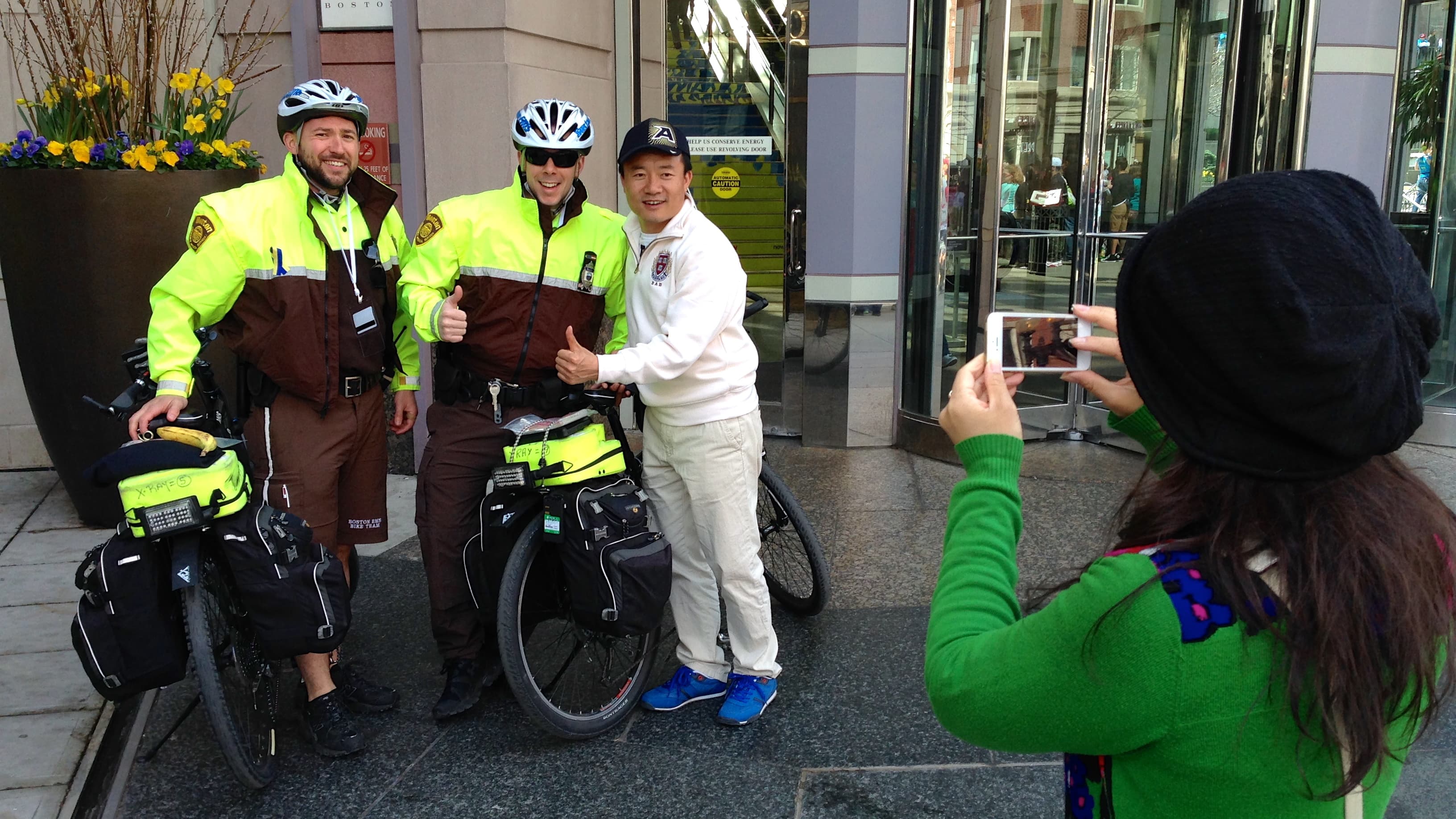 Boston police smile for some tourists from out of town on Marathon Day.