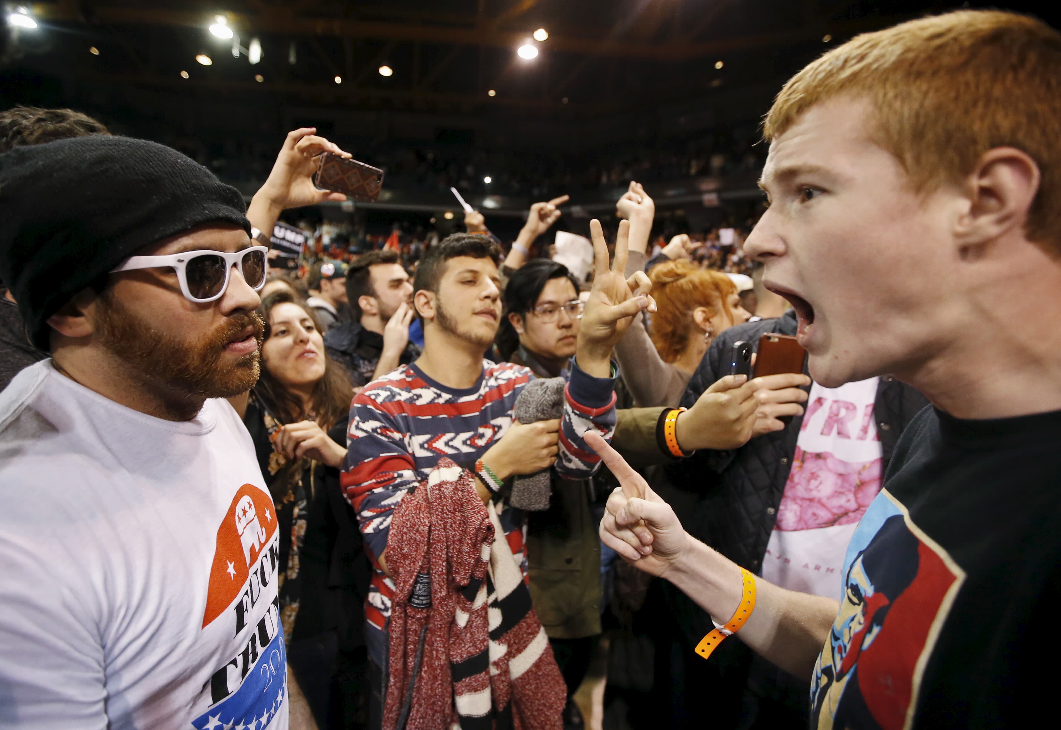A supporter of Republican presidential candidate Donald Trump yells at a demonstrator after Trump canceled his rally at the University of Illinois at Chicago on March 11, 2016.