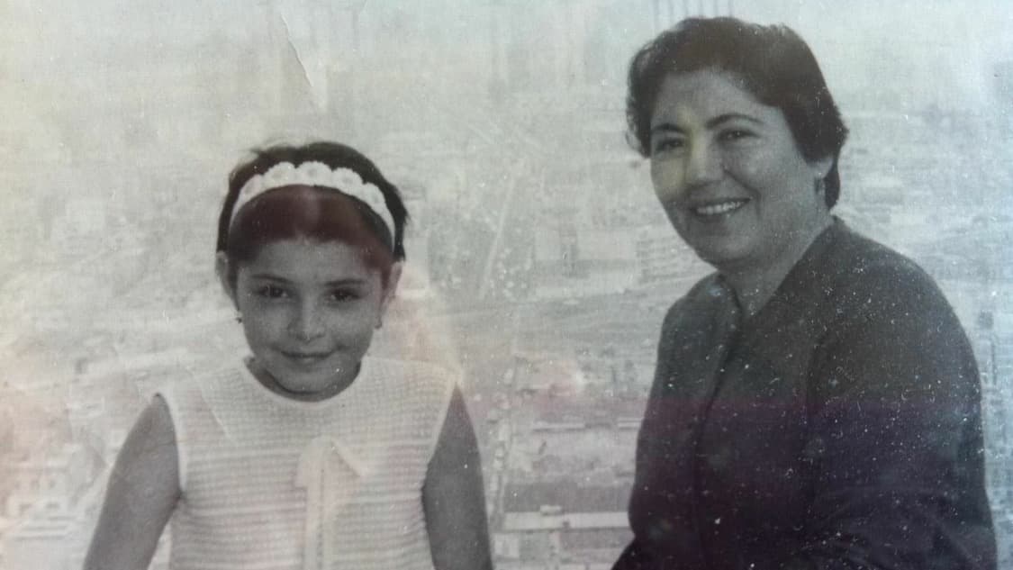 Black and white photo of young girl and mother overlooking city