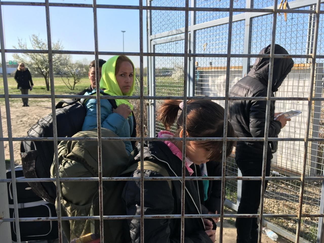 An Afghan family walks toward the Hungary-Serbia border on the day the new law takes effect.  They will live in a detention center until a decision is made on their claim.