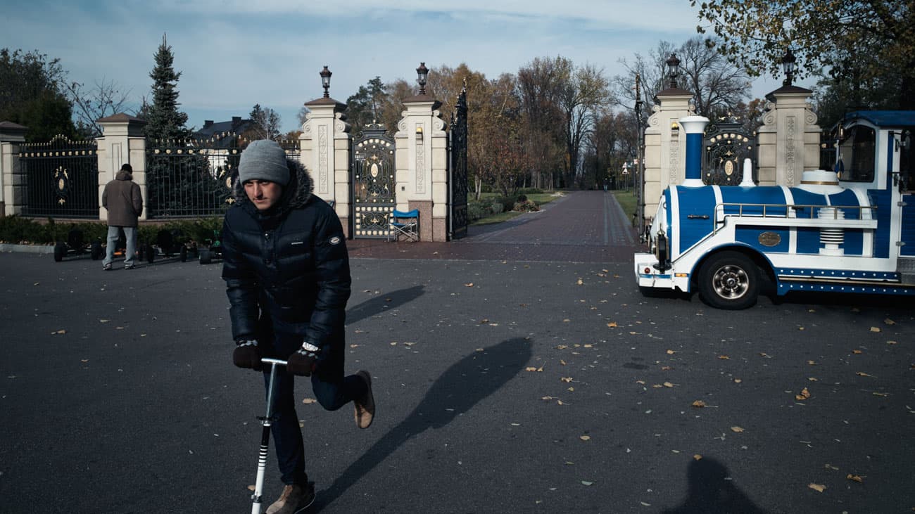 Vendors sell bike rentals, guided tours and memorabilia outside the main entrance to Mezhyhirya.