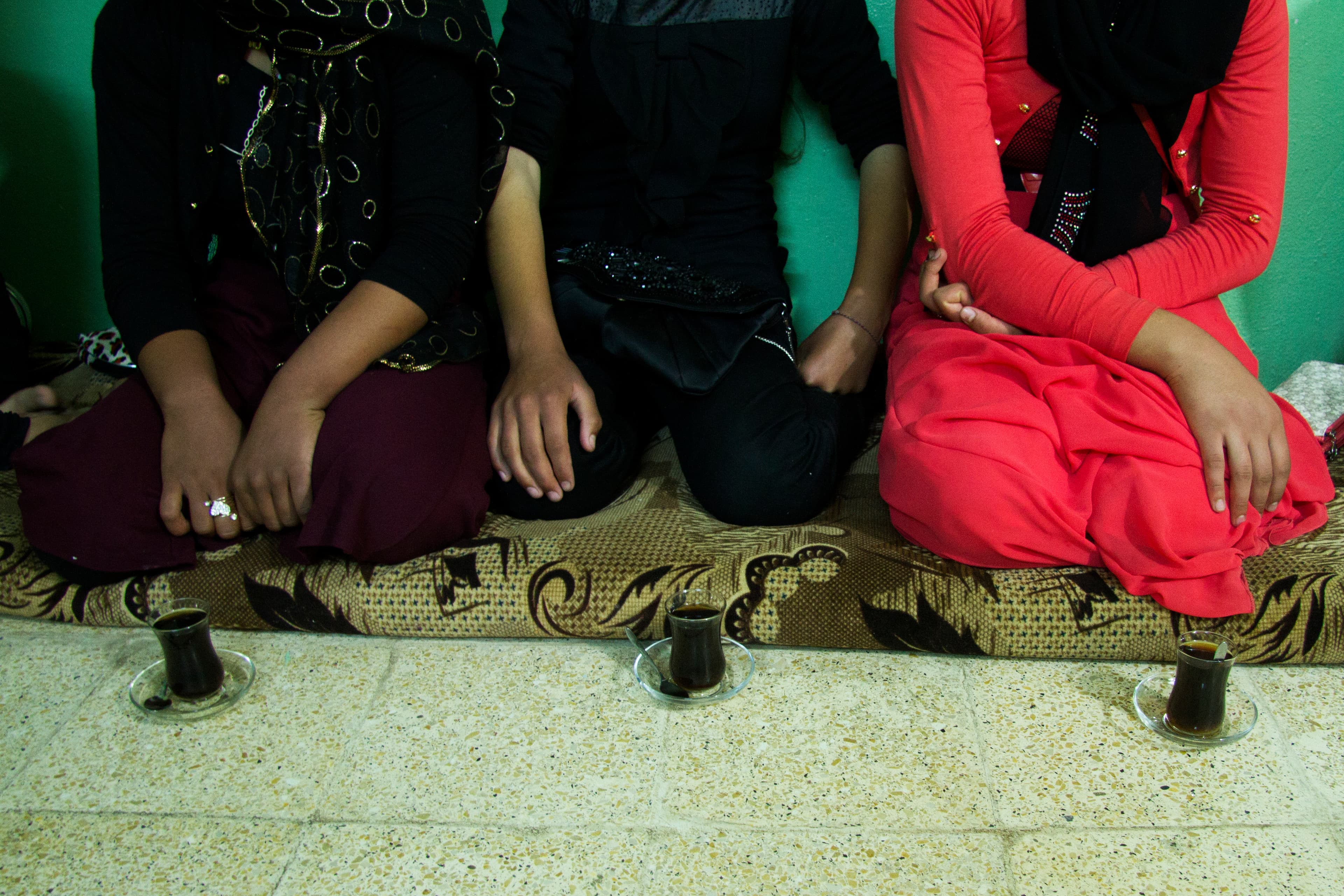 Yazidi women released from ISIS captivity meet with Lalish's top spiritual leader, Baba Chawish, before being baptized back into the faith. They didn't want to show their faces.
