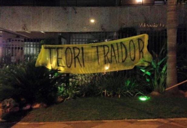 Banner outside Justice's house: 