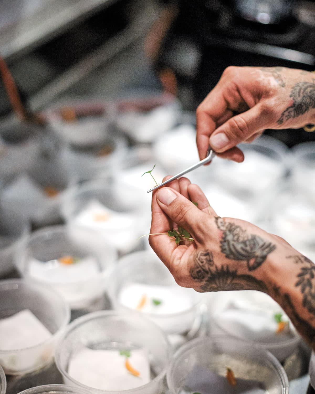 Placing a green leaf on a dish.